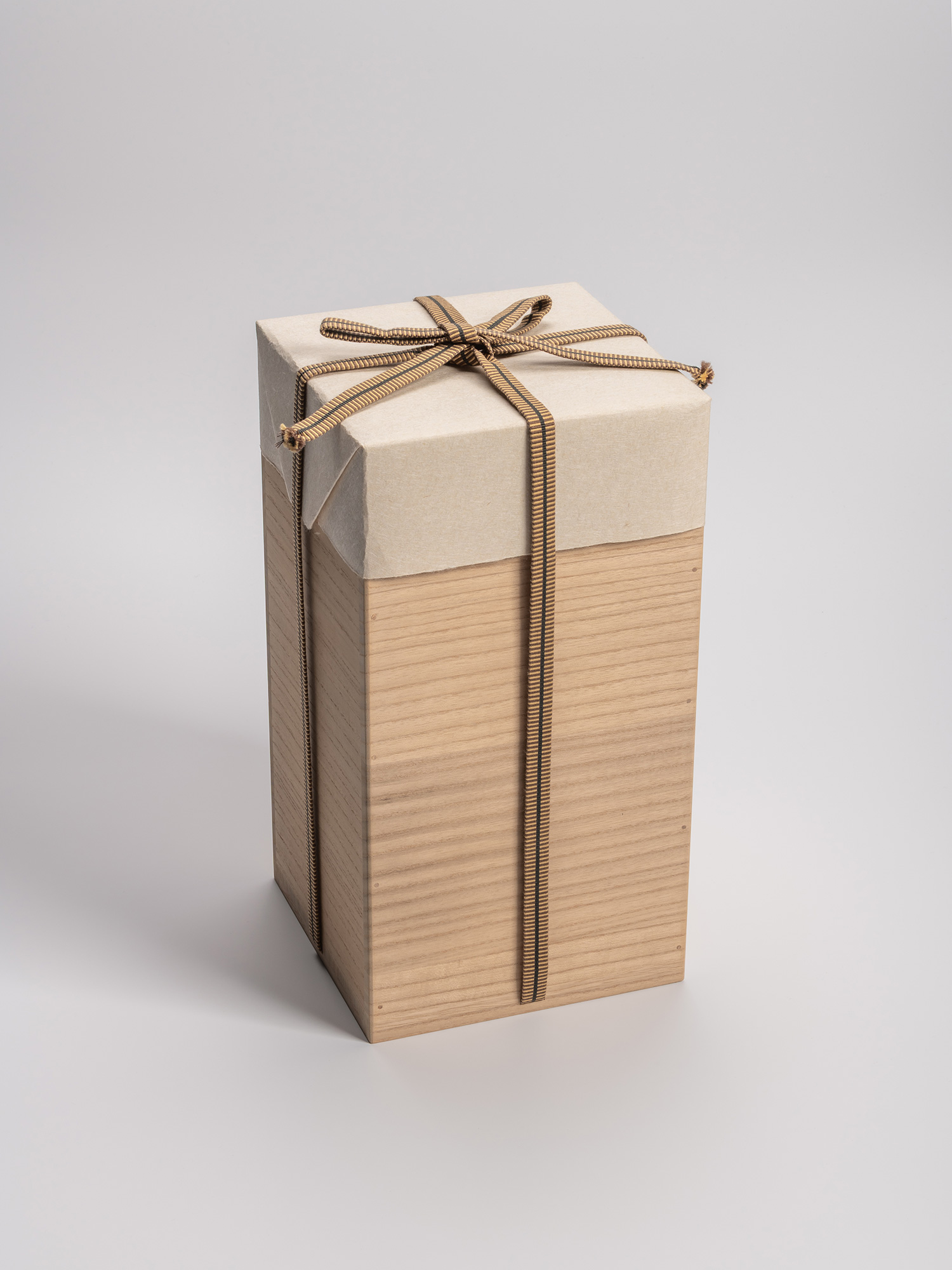 Tall, square wooden tomobako (artist-signed storage box) by ceramic artist, shown with its tan...