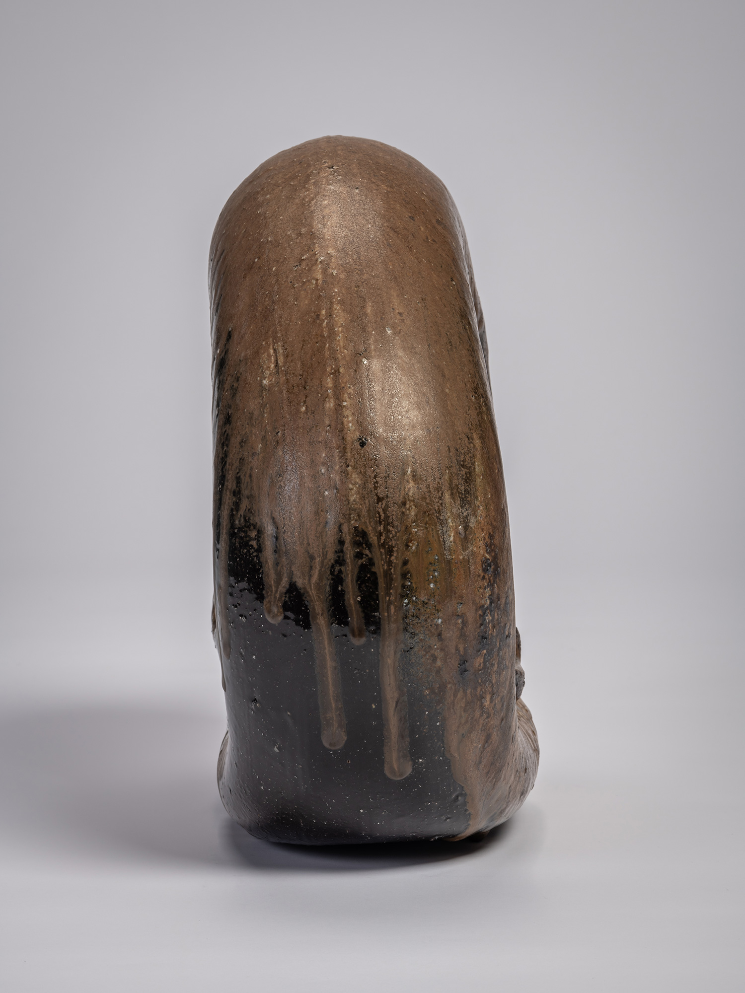 Profile view of the ceramic sculpture Ring by Jun Isezaki, depicting a vertically oriented sculptural...