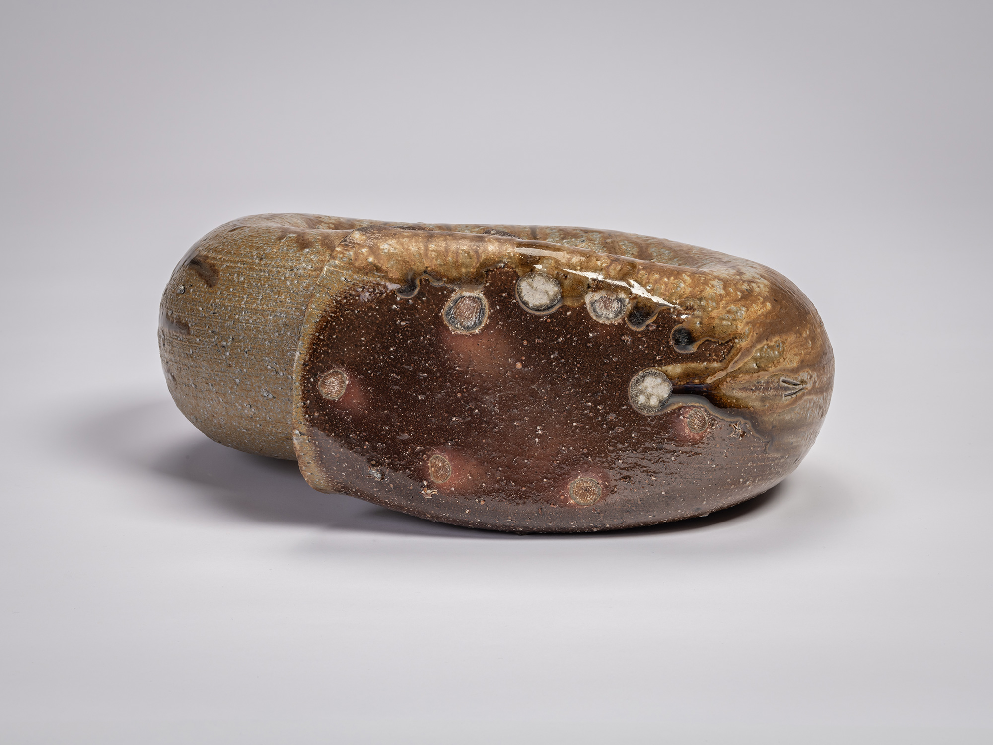 Underside view of the foot of the ceramic sculpture Ring by Jun Isezaki, showing multiple raised...