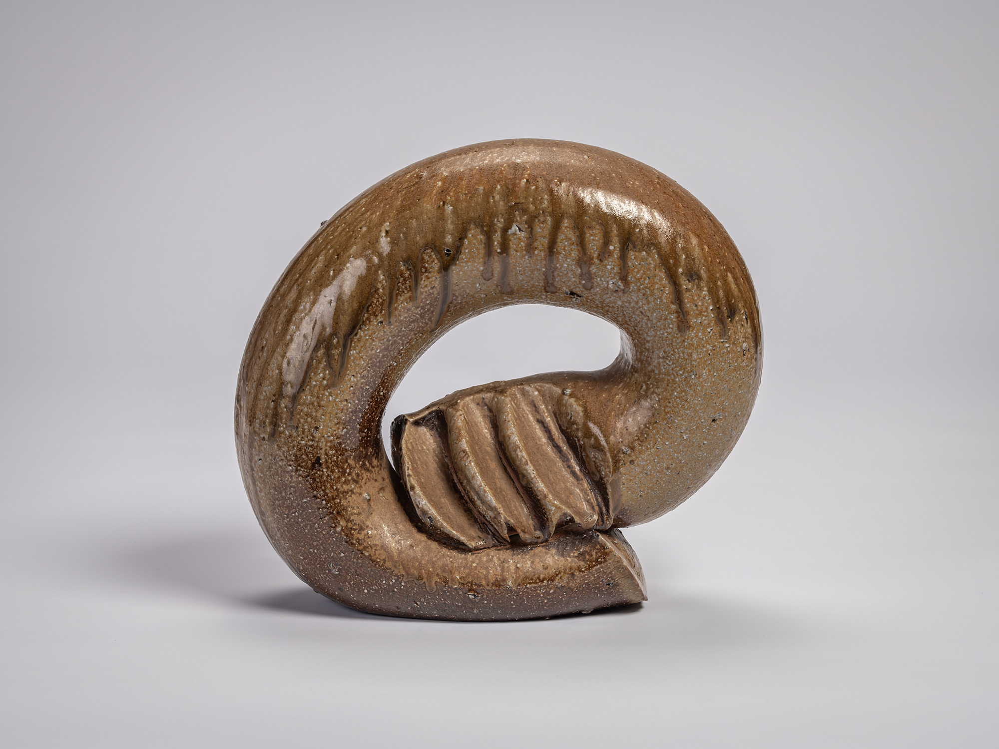 View of the ceramic sculpture Ring by Jun Isezaki, featuring a thick circular form with an open...