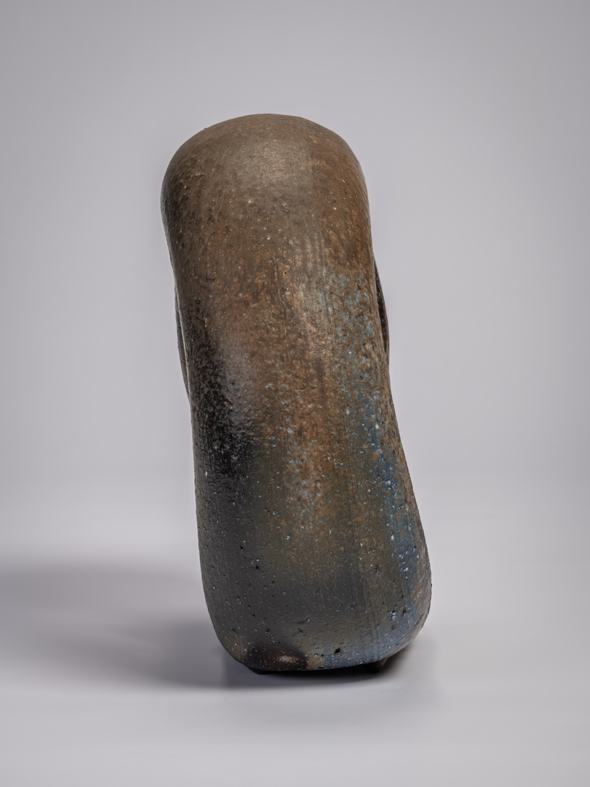 Side view of the ceramic sculpture Ring by Jun Isezaki, showing an elongated, rounded form with...