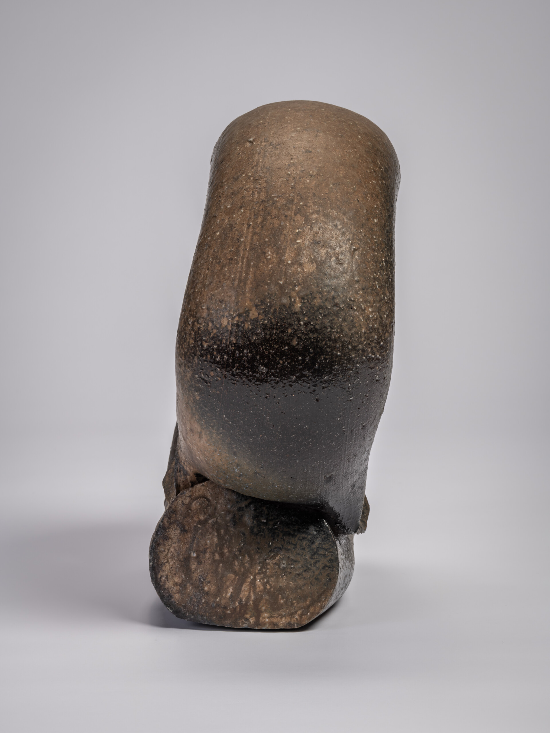 Side view of the ceramic sculpture Ring by Jun Isezaki, showing a thick, vertically oriented curved...