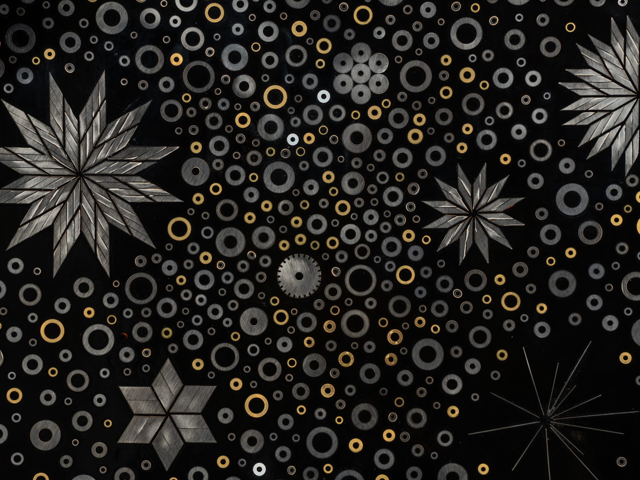 Detail of Stellar Dance by Genta Ishizuka showing layered fields of circular metal washers interspersed...