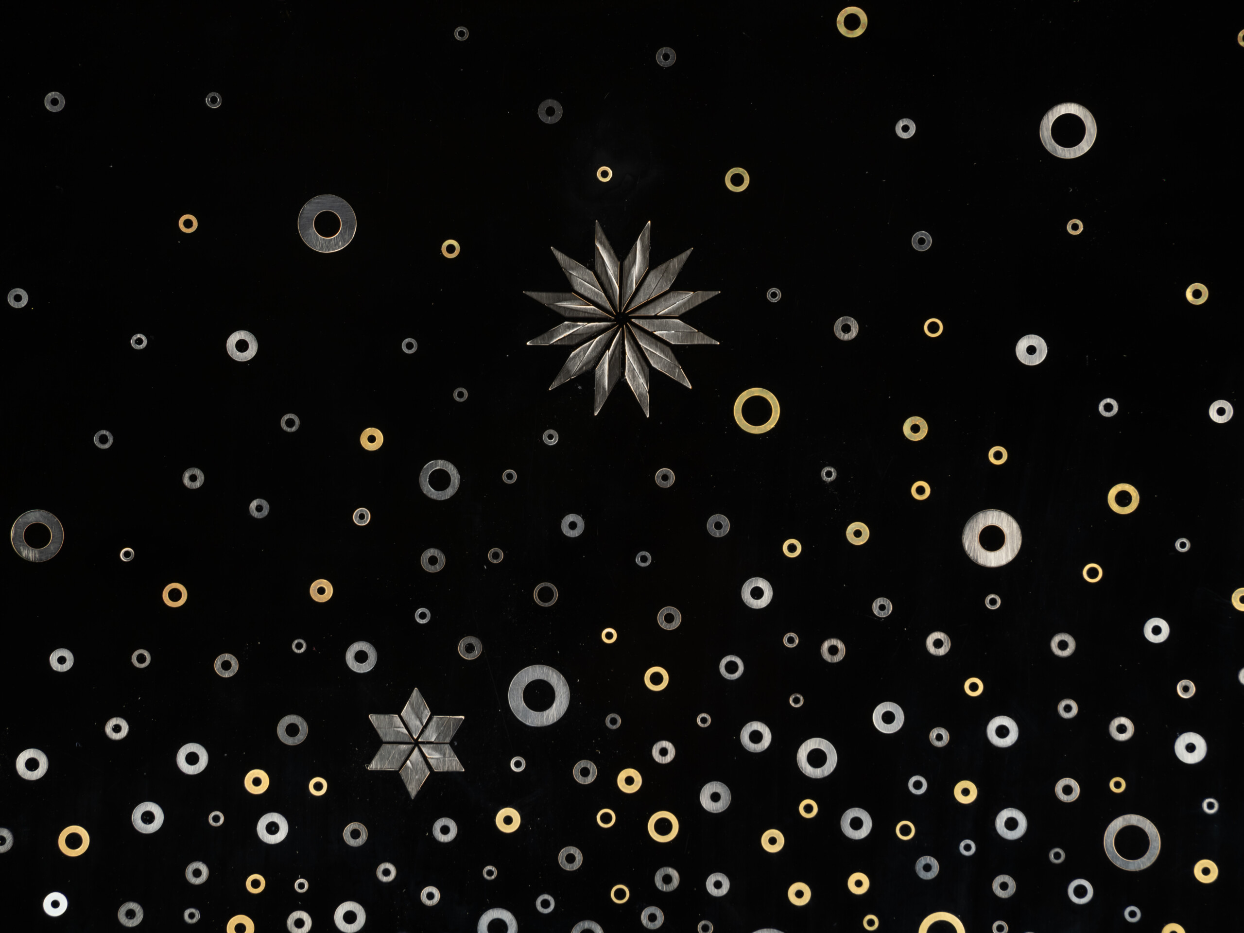 Detail of Stellar Dance by Genta Ishizuka featuring a solitary starburst assembled from layered...