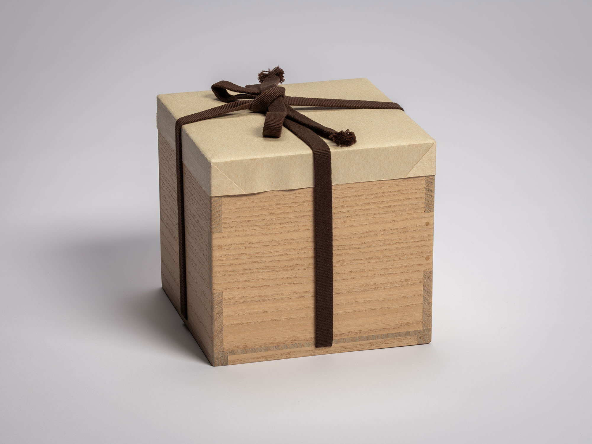 Exterior view of a light-toned paulownia wood storage box (tomobako) for the Asahi tea bowl, featuring...