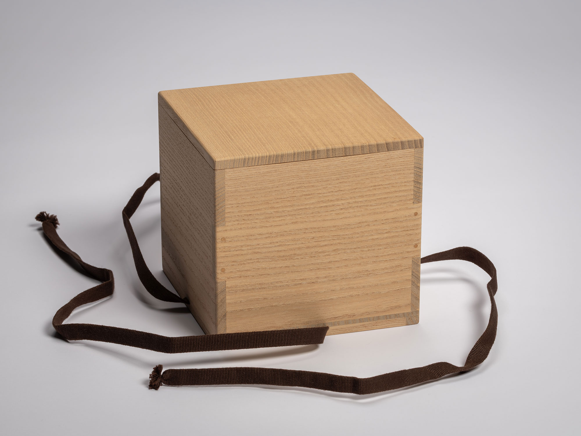 Exterior view of a light-toned paulownia wood storage box (tomobako) for the Asahi tea bowl, featuring...
