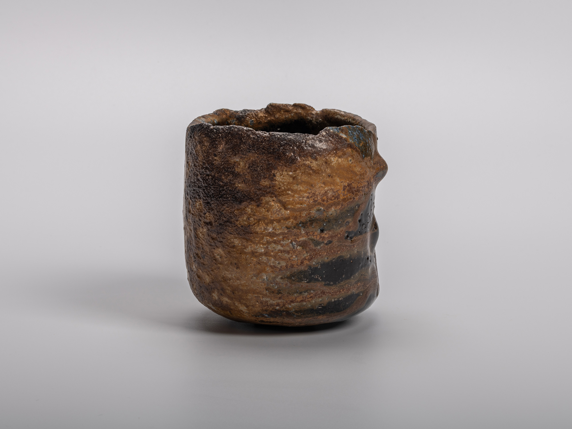 Black tea bowl by Kakurezaki Ryūichi, featuring a sculptural cylindrical form with an irregular...