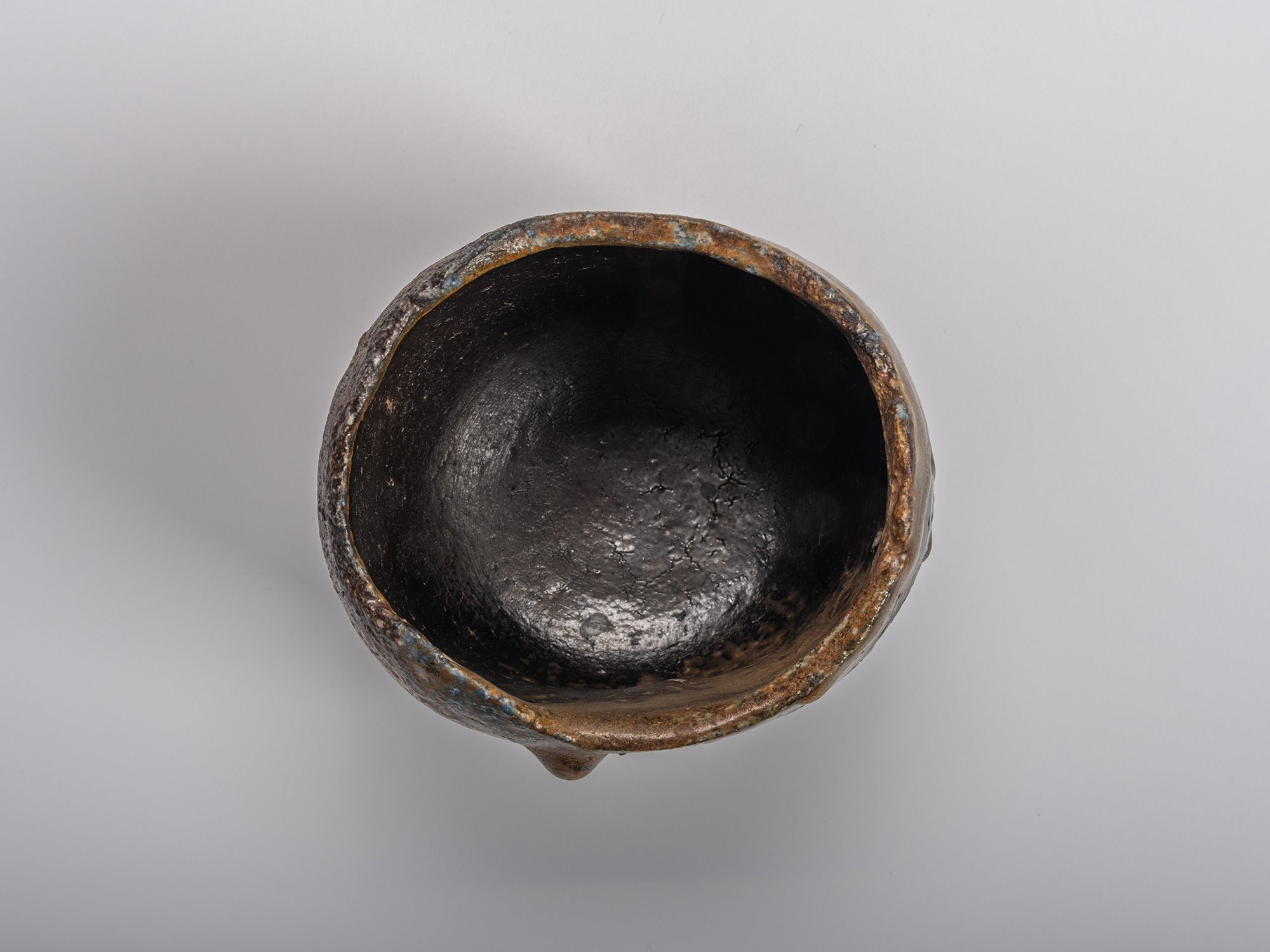 Interior (mikomi) of a black tea bowl by Kakurezaki Ryūichi, showing a deep, lustrous black surface...