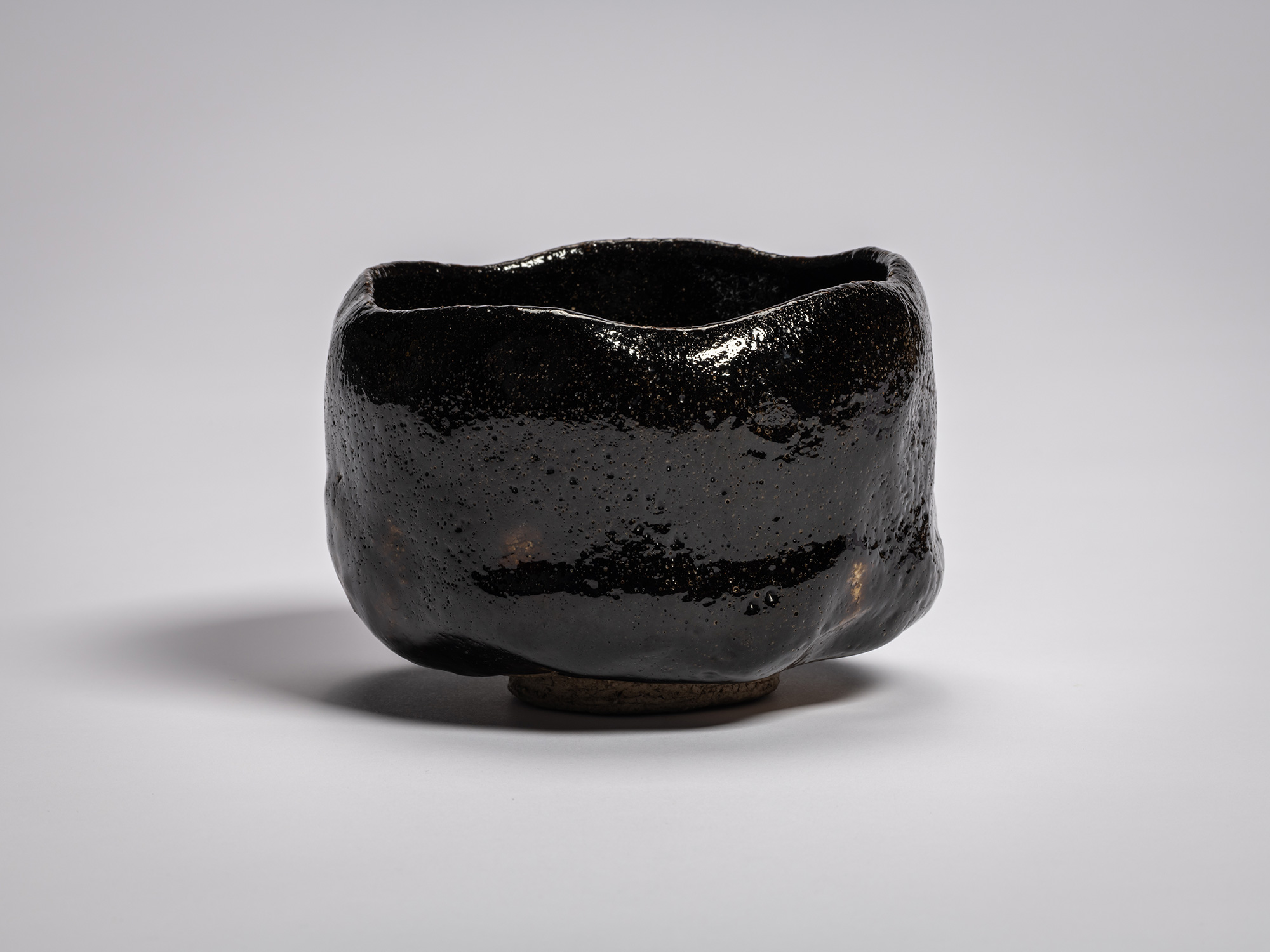 Profile view of the authentic black Raku tea bowl named Chitose (A Thousand Years) by Raku XI (Keinyū)....