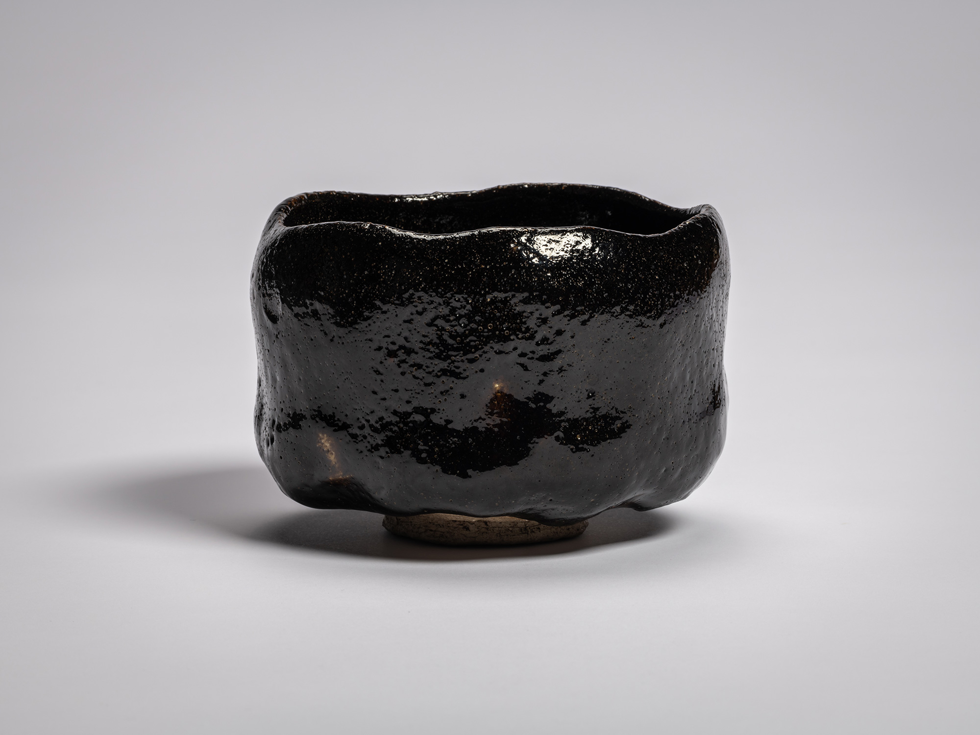 Profile view of the authentic black Raku tea bowl named Chitose (A Thousand Years) by Raku XI (Keinyū)....