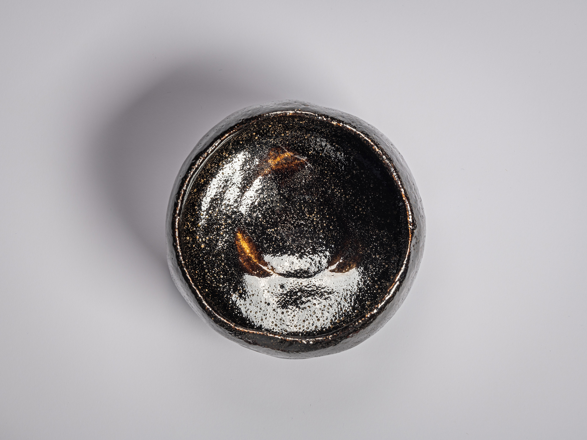 Overhead perspective of the interior of the Chitose black Raku tea bowl by Raku XI (Keinyū), handcrafted...