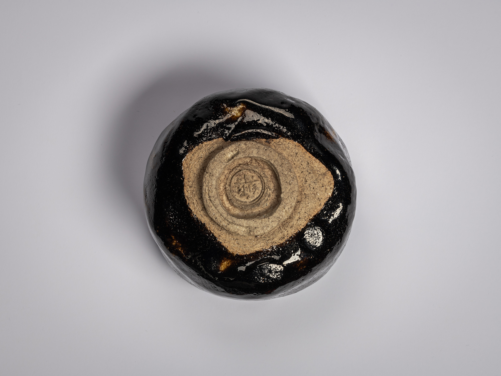 Overhead view of the base (kodai) of the Chitose black Raku tea bowl by Raku XI (Keinyū), showing...