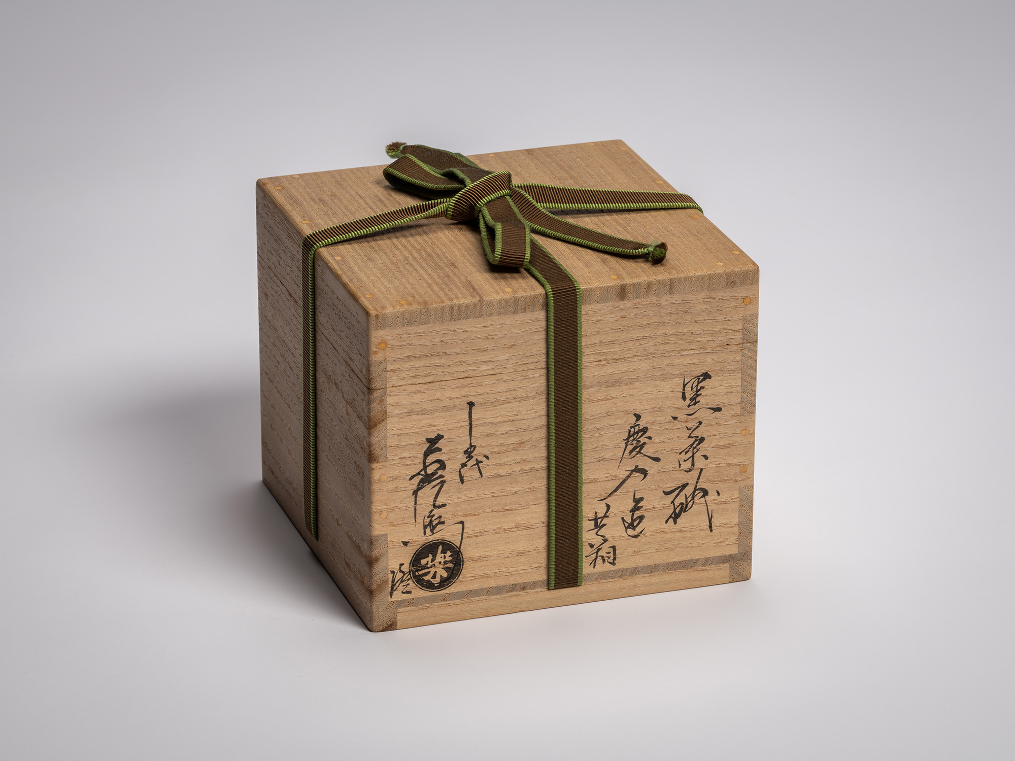 Exterior view of a square paulownia wood storage box (tomobako) for a Black Raku tea bowl by Raku...