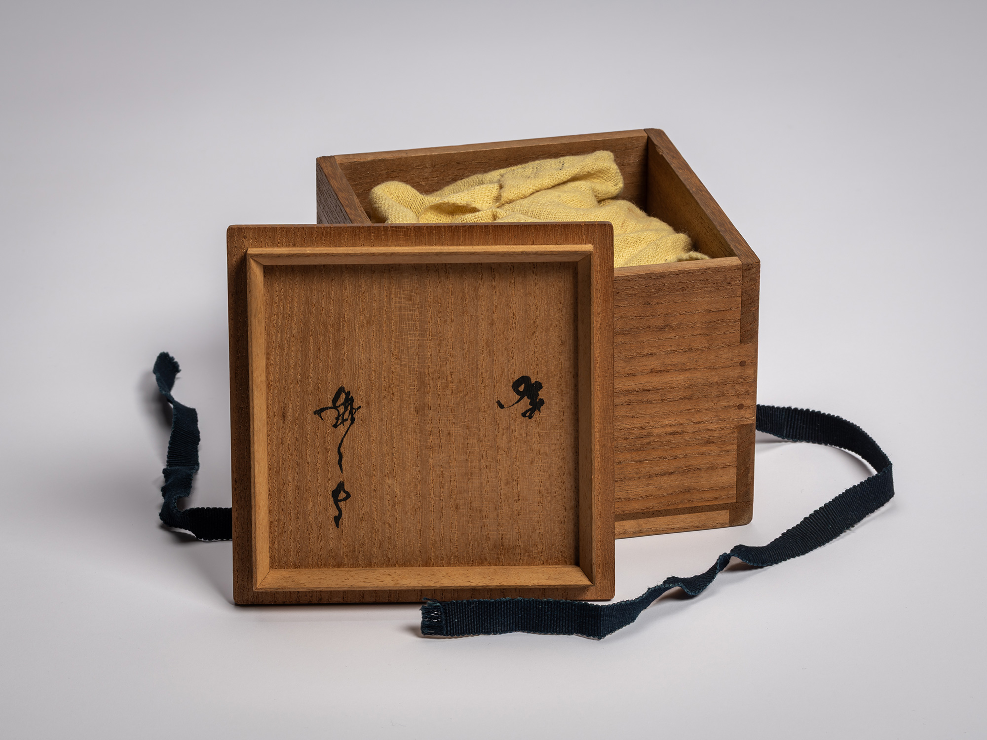 A close-up view of the interior side of a paulownia wood lid for the Chitose tea bowl by Raku XI...