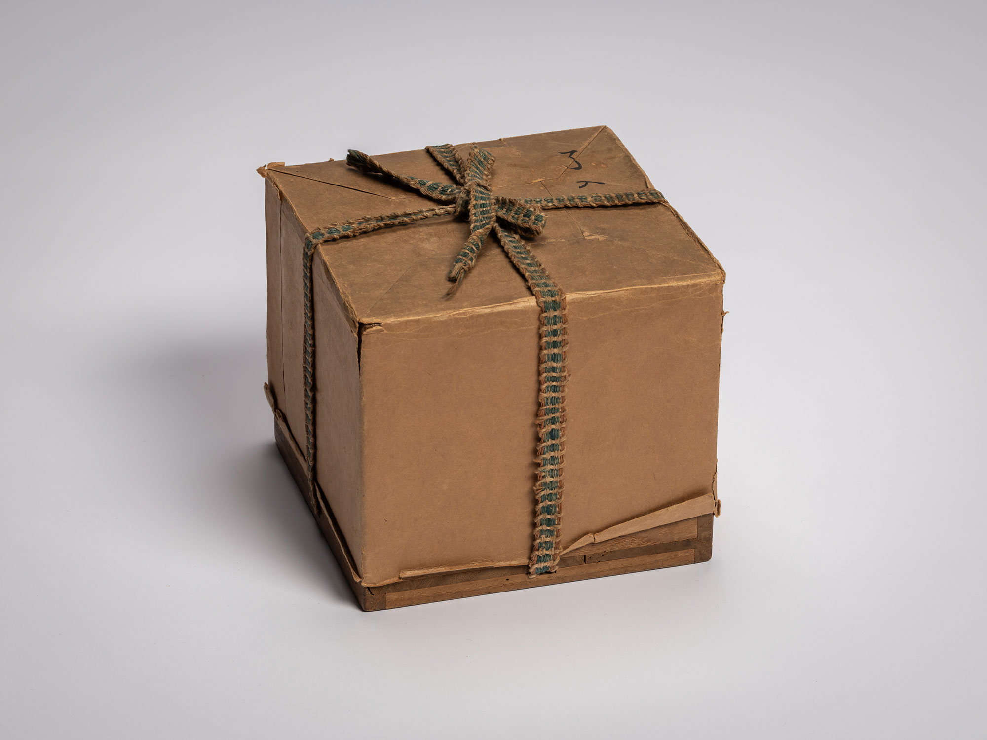 Interior storage box for the tea bowl Daiyūhō (Great Peak) by Raku IX, wrapped in plain brown paper...