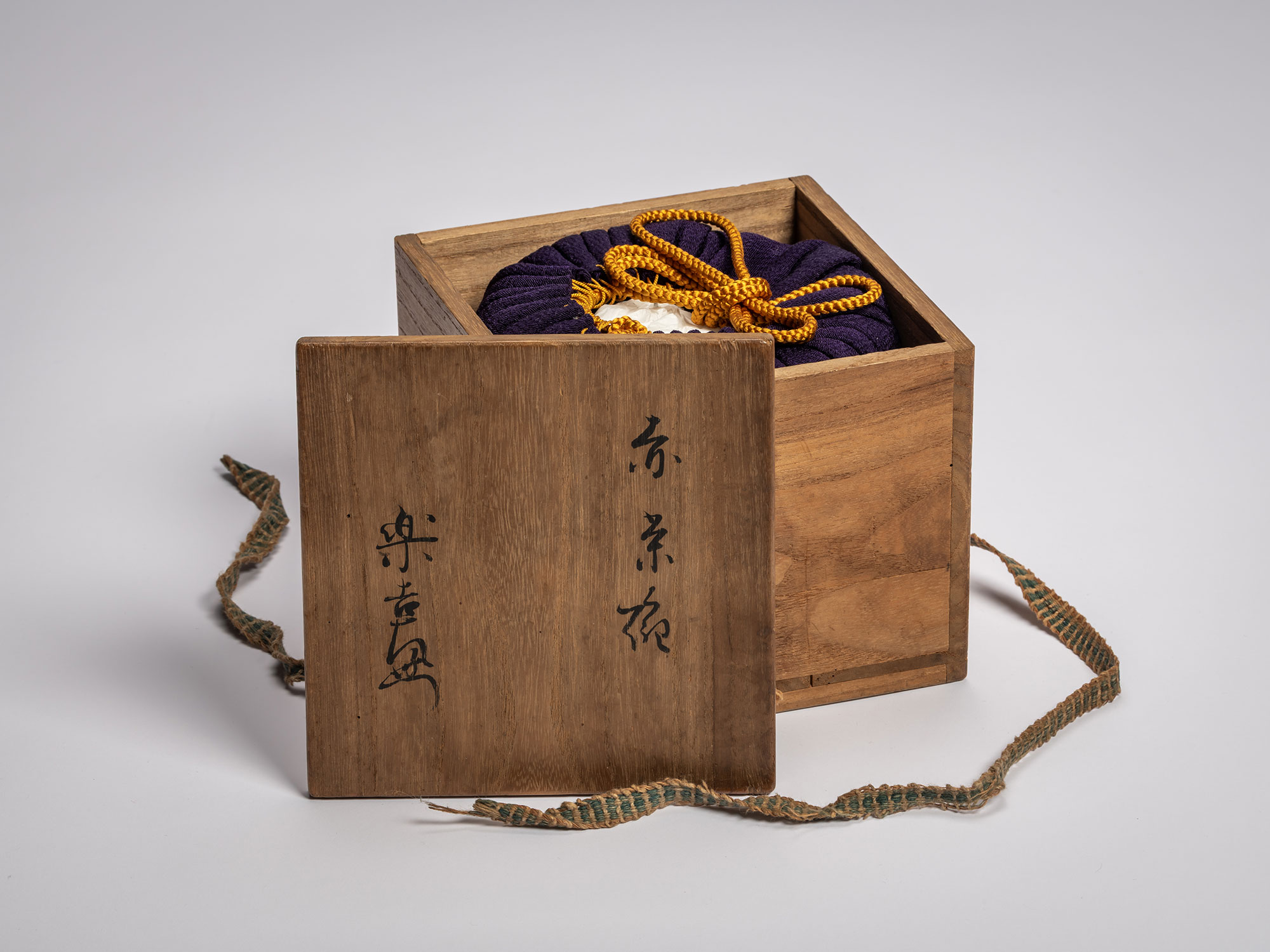 Exterior view of a dark wood secondary tomobako lid featuring formal ink calligraphy by Raku IX....