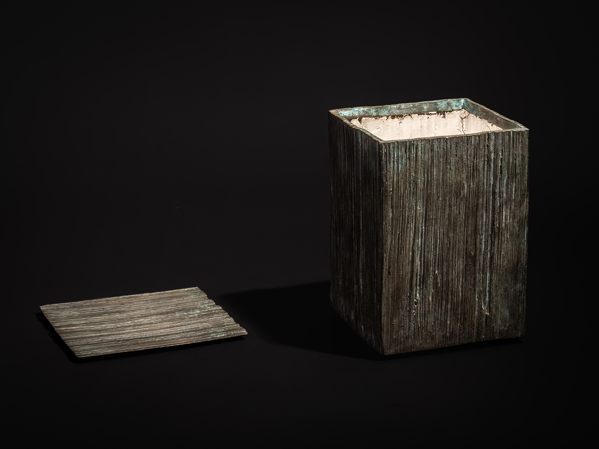 Single photograph showing the bronze box and detached lid from Green Expression by Koji Hatakeyama...