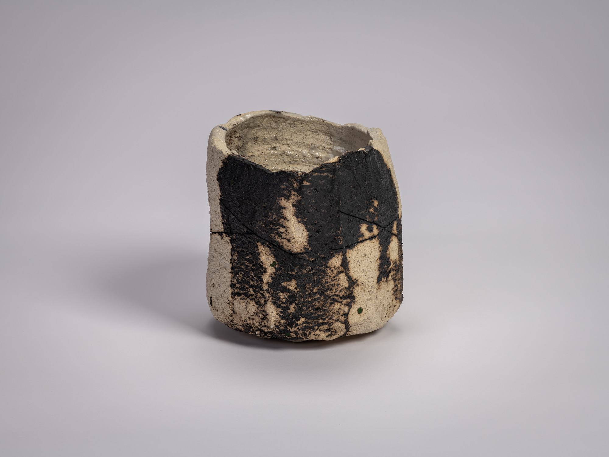 Side view of tea bowl Gyō by Raku XV (Jikinyū), formed from white rock clay with a cylindrical,...