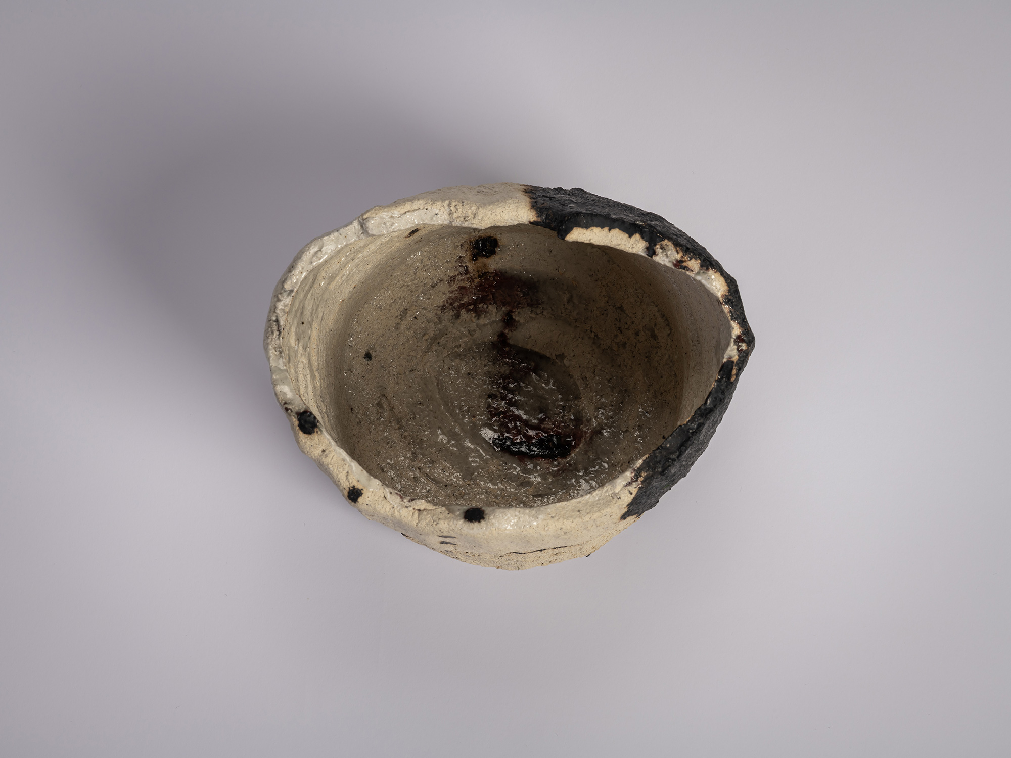 Interior (mikomi) of the white rock tea bowl Gyō by Raku XV (Jikinyū), showing a softly glazed...