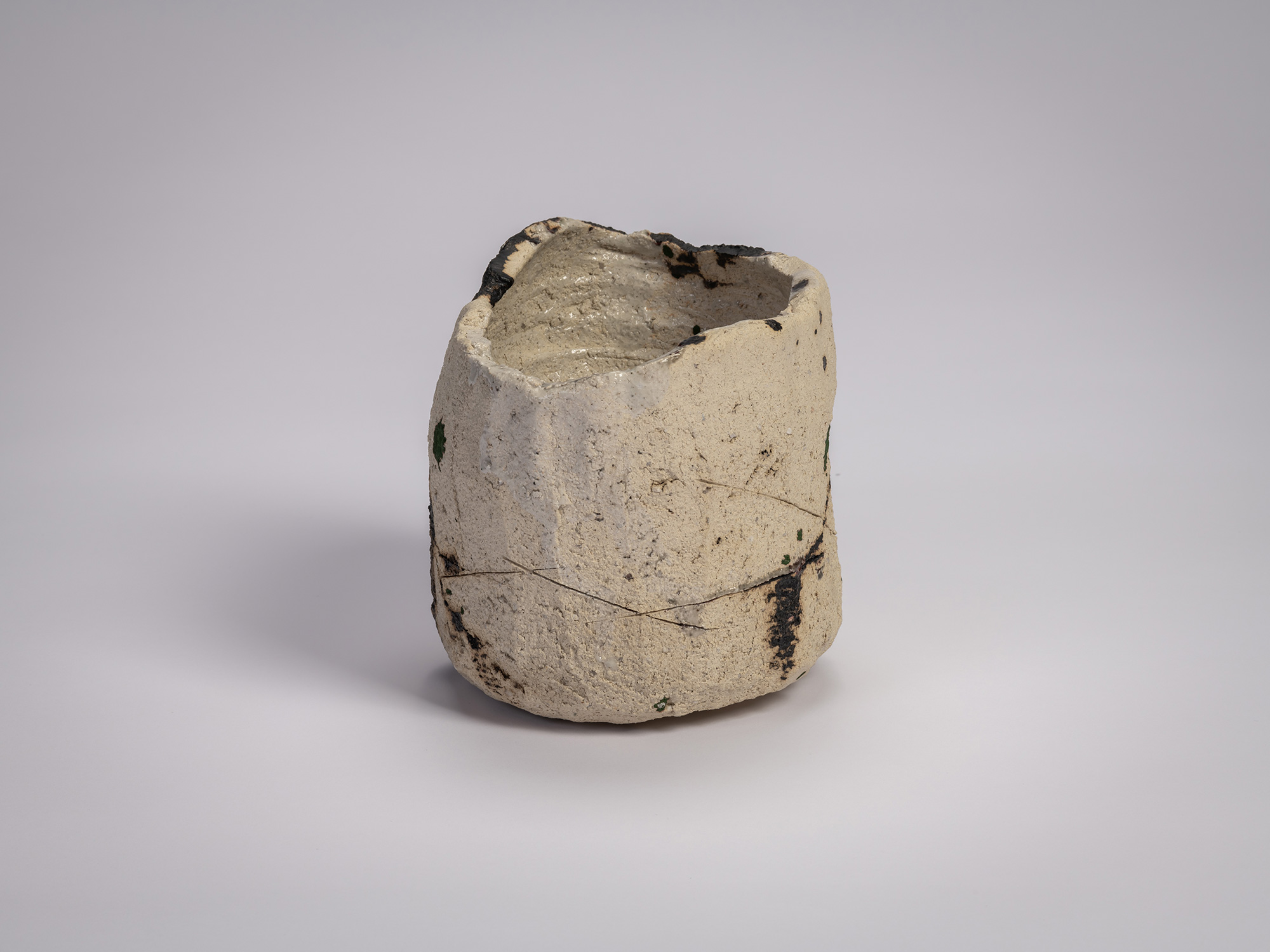 Side view of tea bowl Gyō by Raku XV (Jikinyū), formed from white rock clay with a cylindrical,...