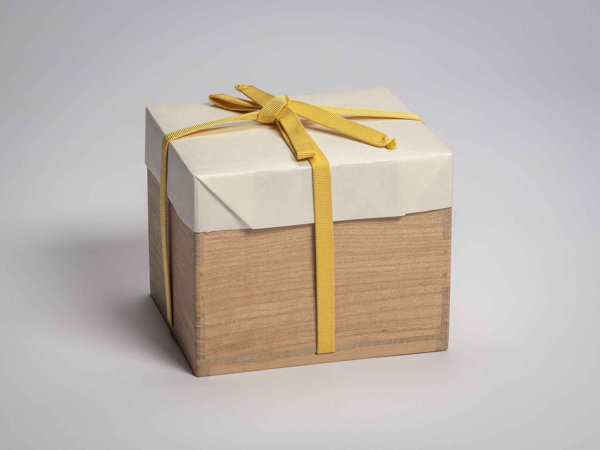 Wooden artist box containing the tea bowl Hekikai Mugen by Raku XV (Jikinyū), tied with a yellow...