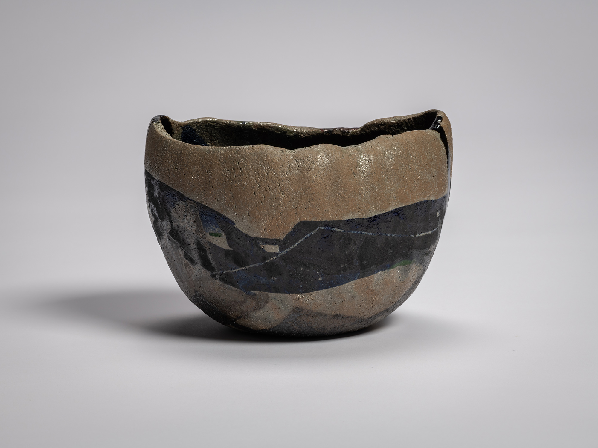 Raku XV tea bowl Hekikai Mugen (“Infinite Profound Blue”) showing a contrast between raw, unglazed...