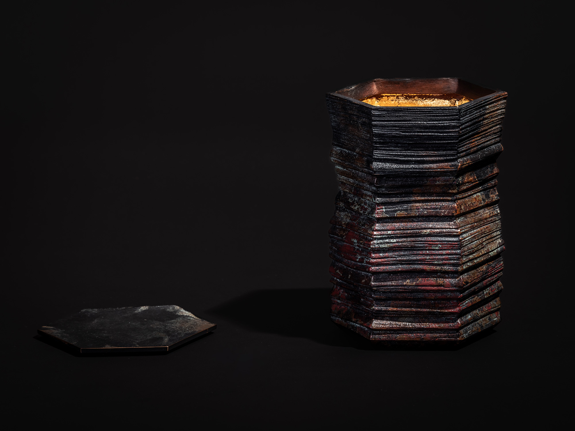 Single photograph of Hexagonal Strips by Koji Hatakeyama with the lid removed. The tall, hexagonal...