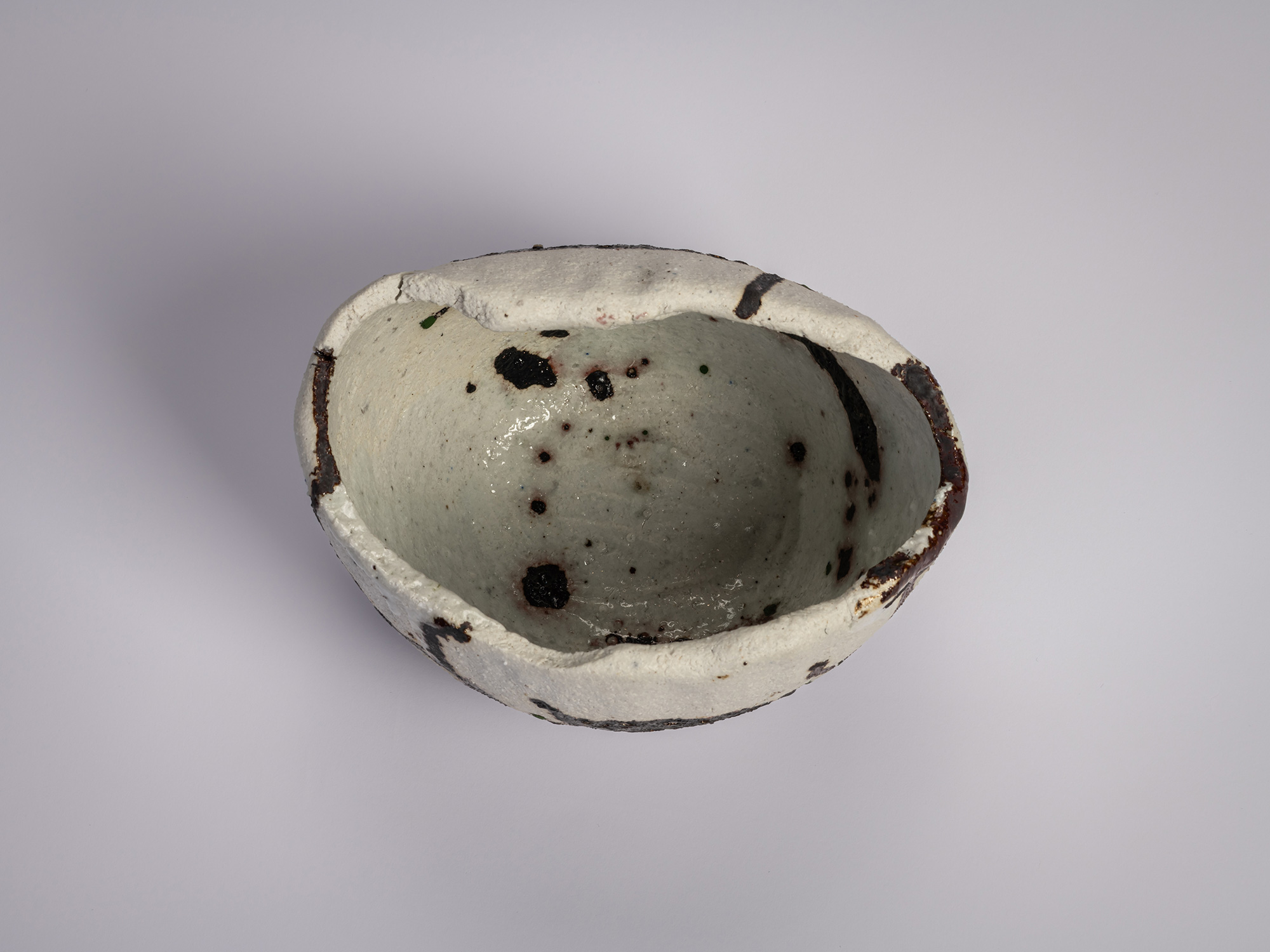 Interior (mikomi) of the tea bowl Hyō by Raku XV (Jikinyū), showing a softly glazed pale surface...