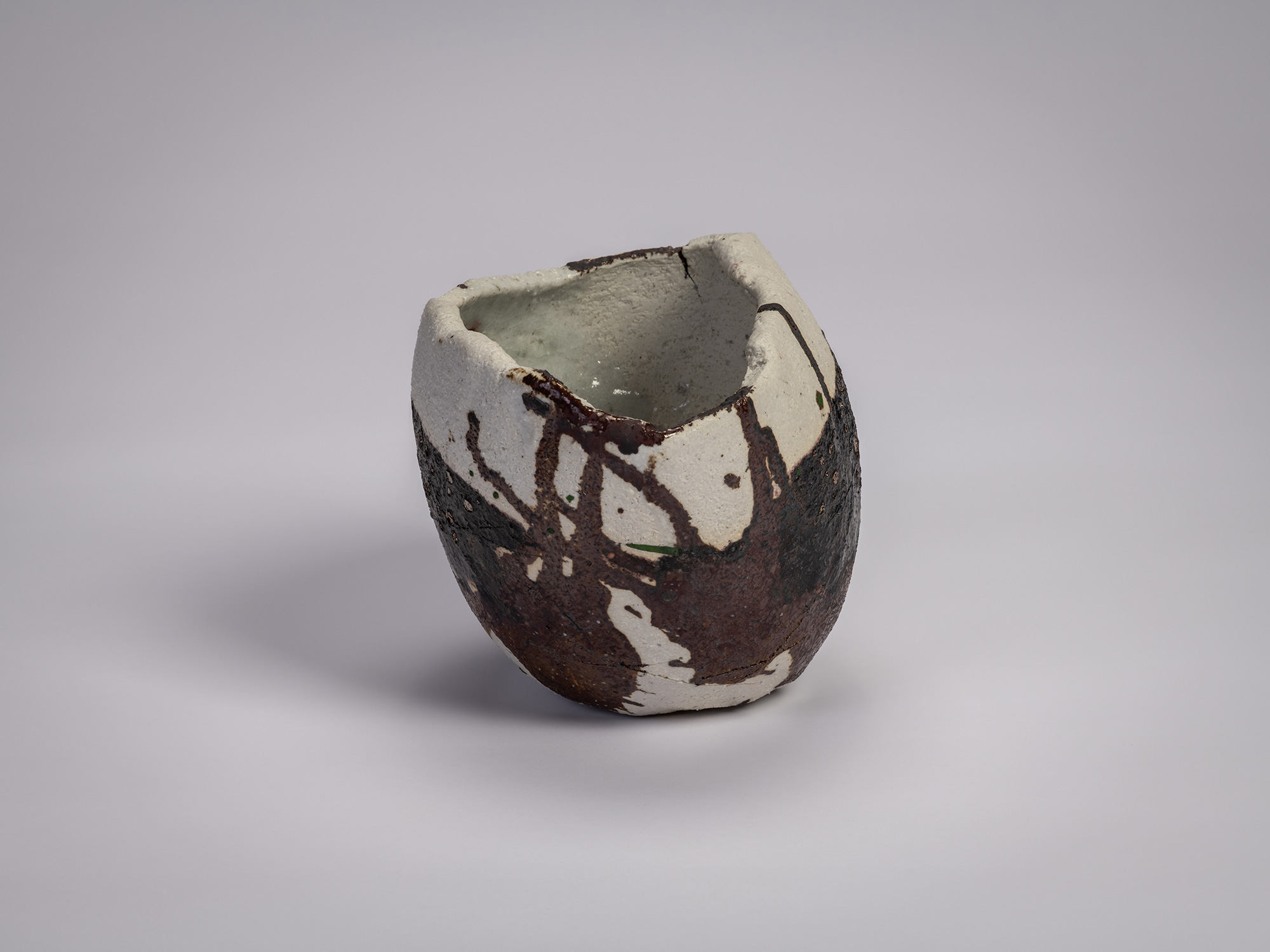 Side view of Tea bowl Hyō by Raku XV (Jikinyū), featuring an irregular hand-formed shape with a...