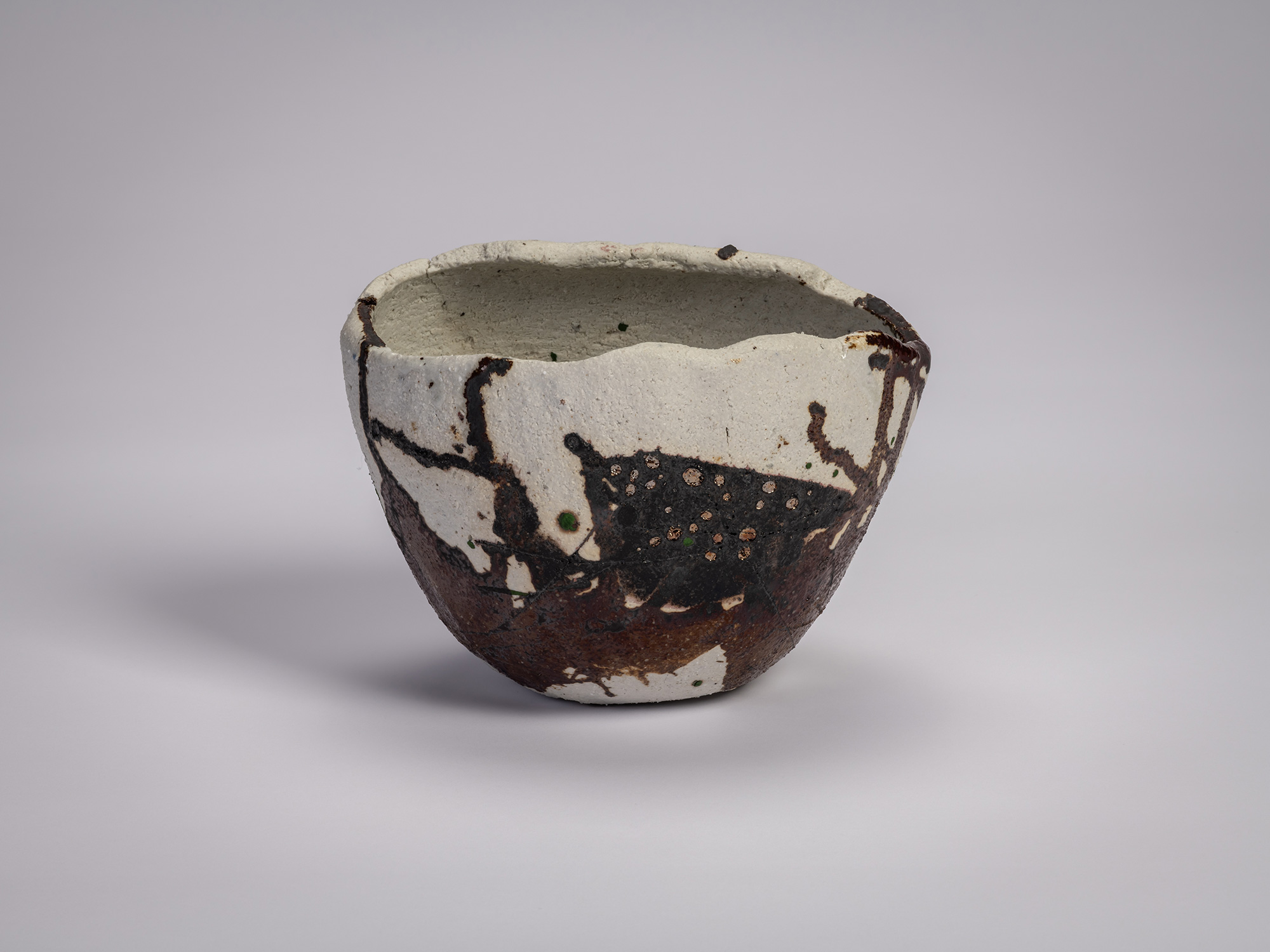 Tea bowl Hyō by Raku XV (Jikinyū), featuring an irregular hand-formed shape with a pale clay body,...