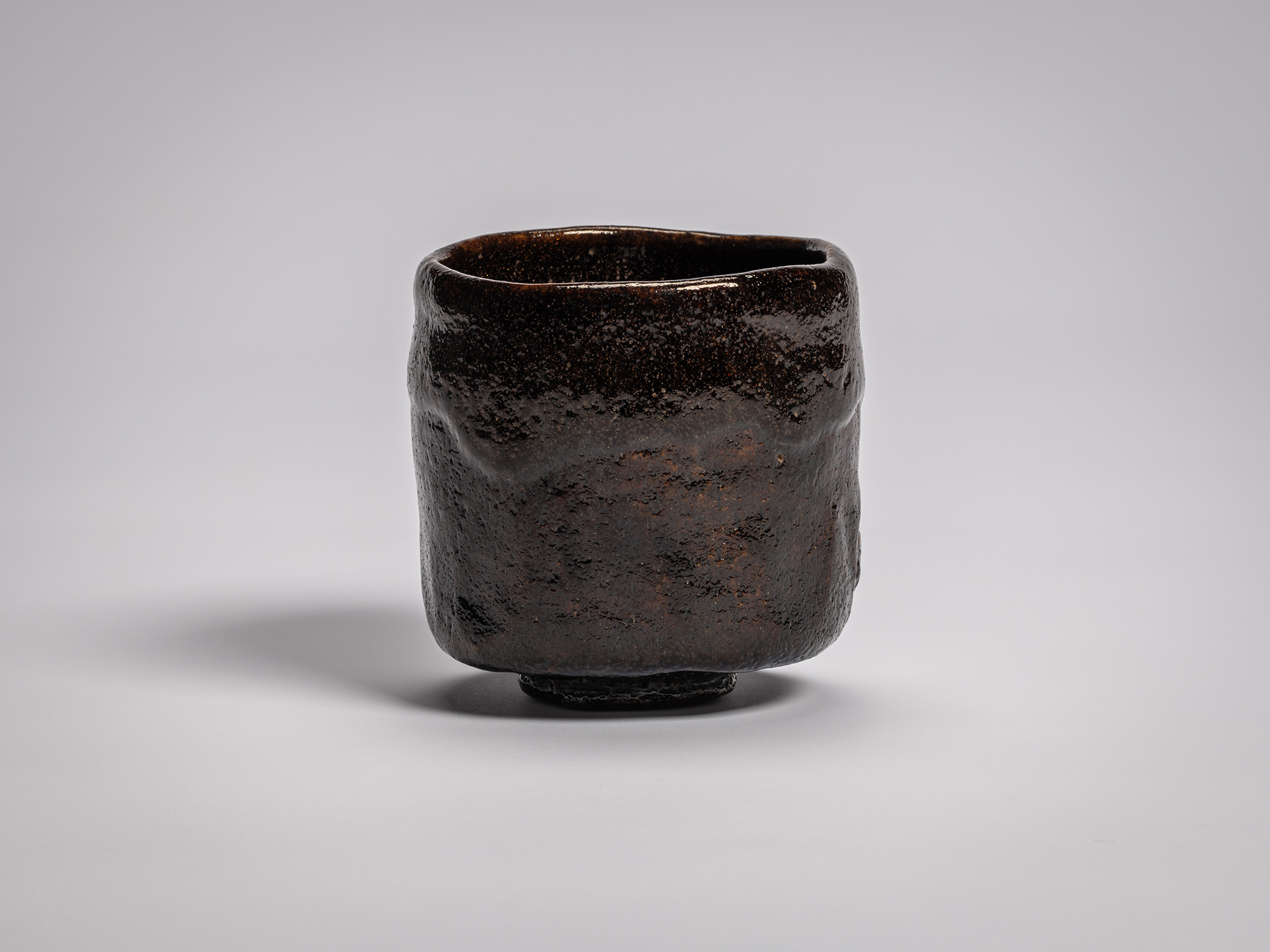 Black Raku tea bowl by Raku VIII, Konoshitayami (Darkness Below Trees), featuring a cylindrical...