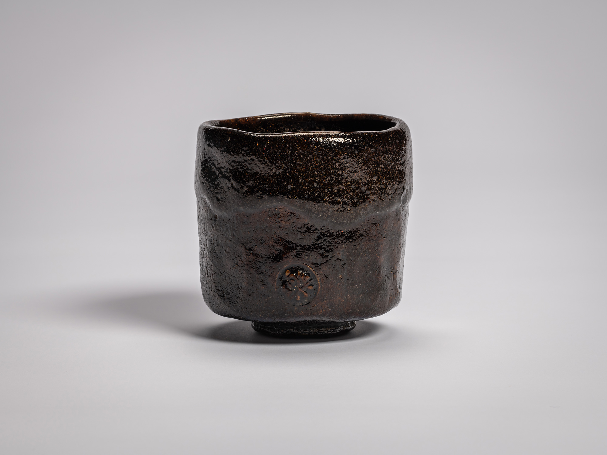 Black Raku tea bowl by Raku VIII, Konoshitayami (Darkness Below Trees), featuring a cylindrical...