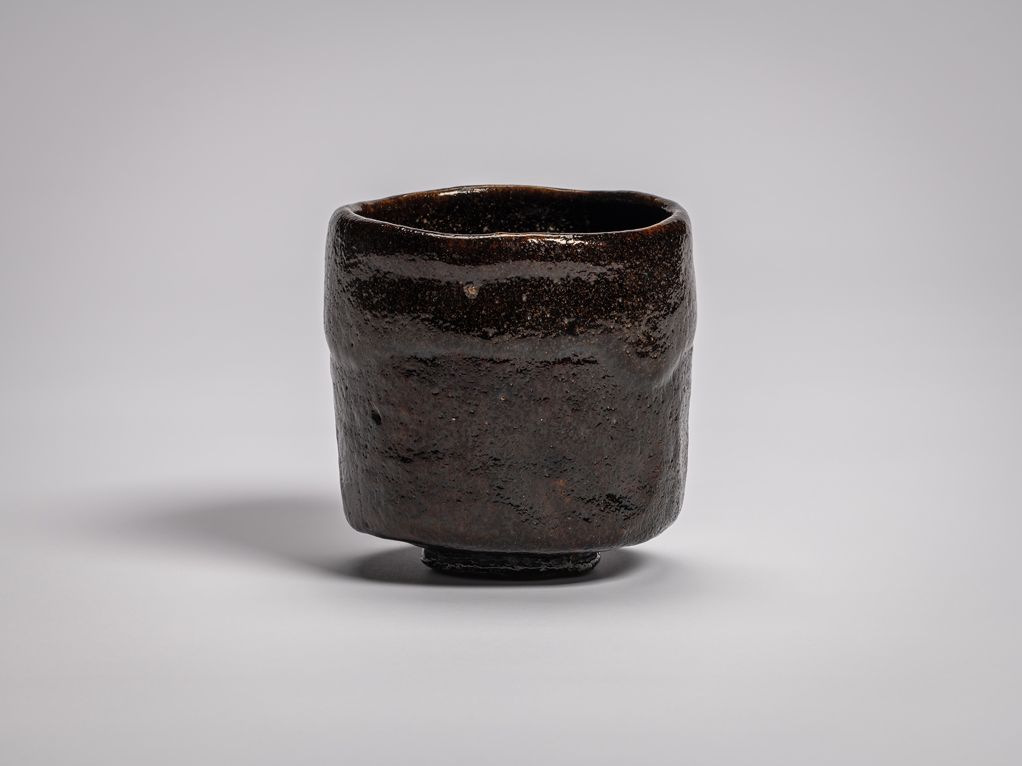 Black Raku tea bowl by Raku VIII, Konoshitayami (Darkness Below Trees), featuring a cylindrical...
