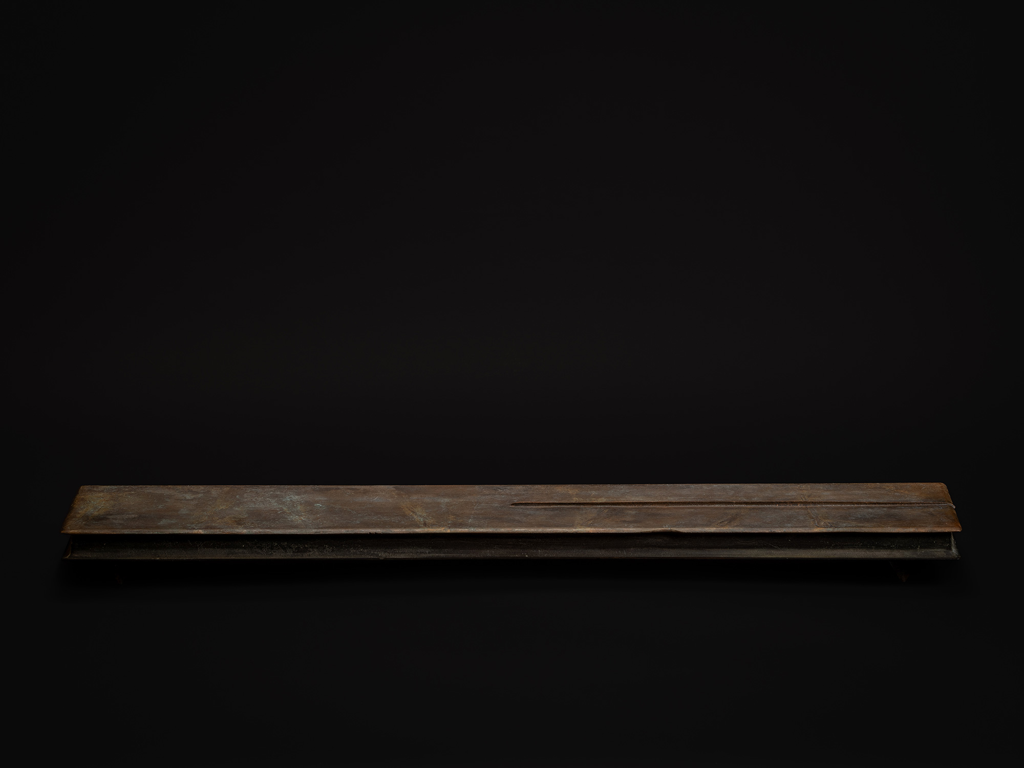 Rectangular bronze box by Koji Hatakeyama, shown in a long horizontal profile with a subtle raised...