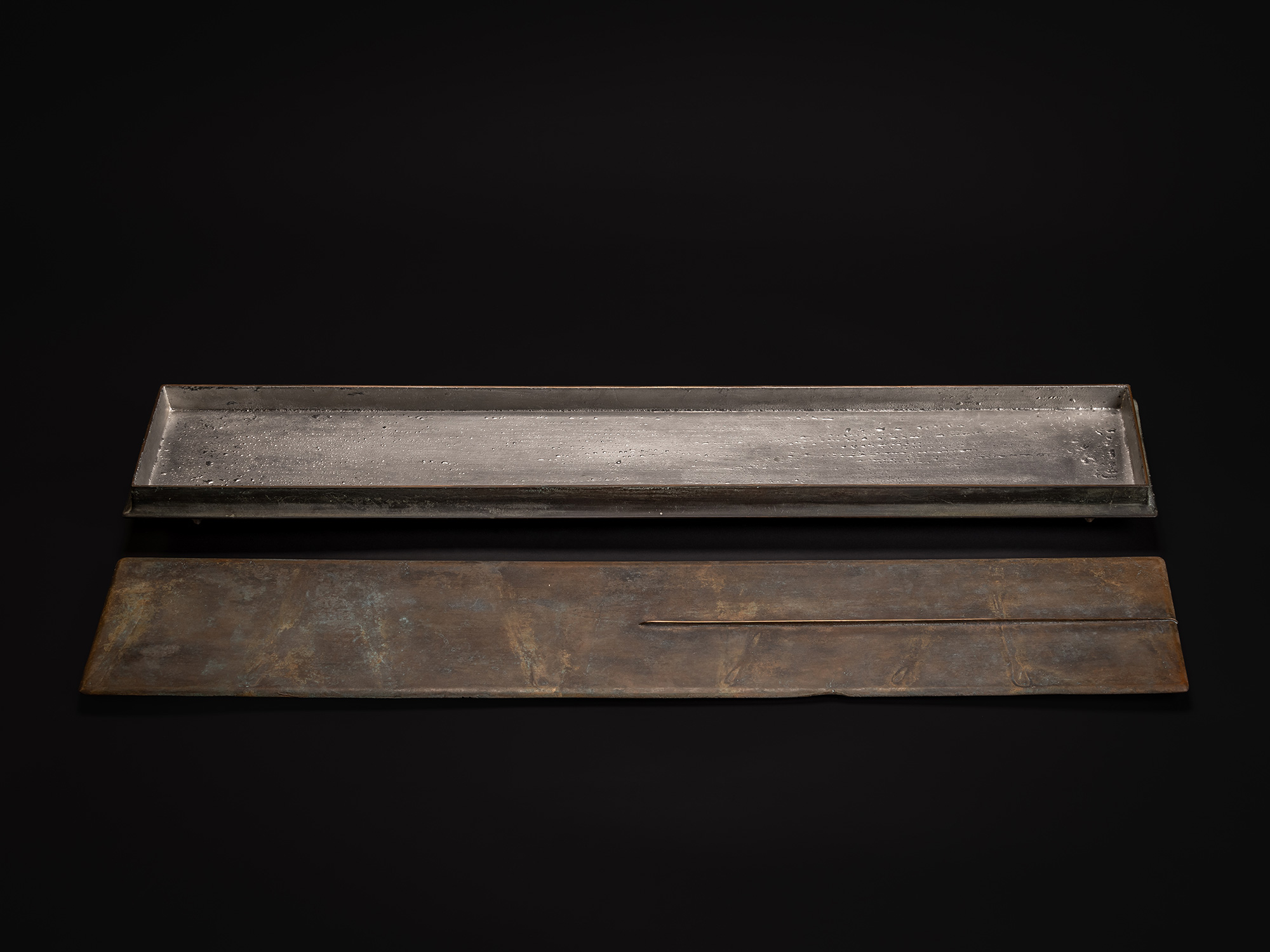 Rectangular bronze box by Koji Hatakeyama, shown open with the lid removed, revealing the raw bronze...