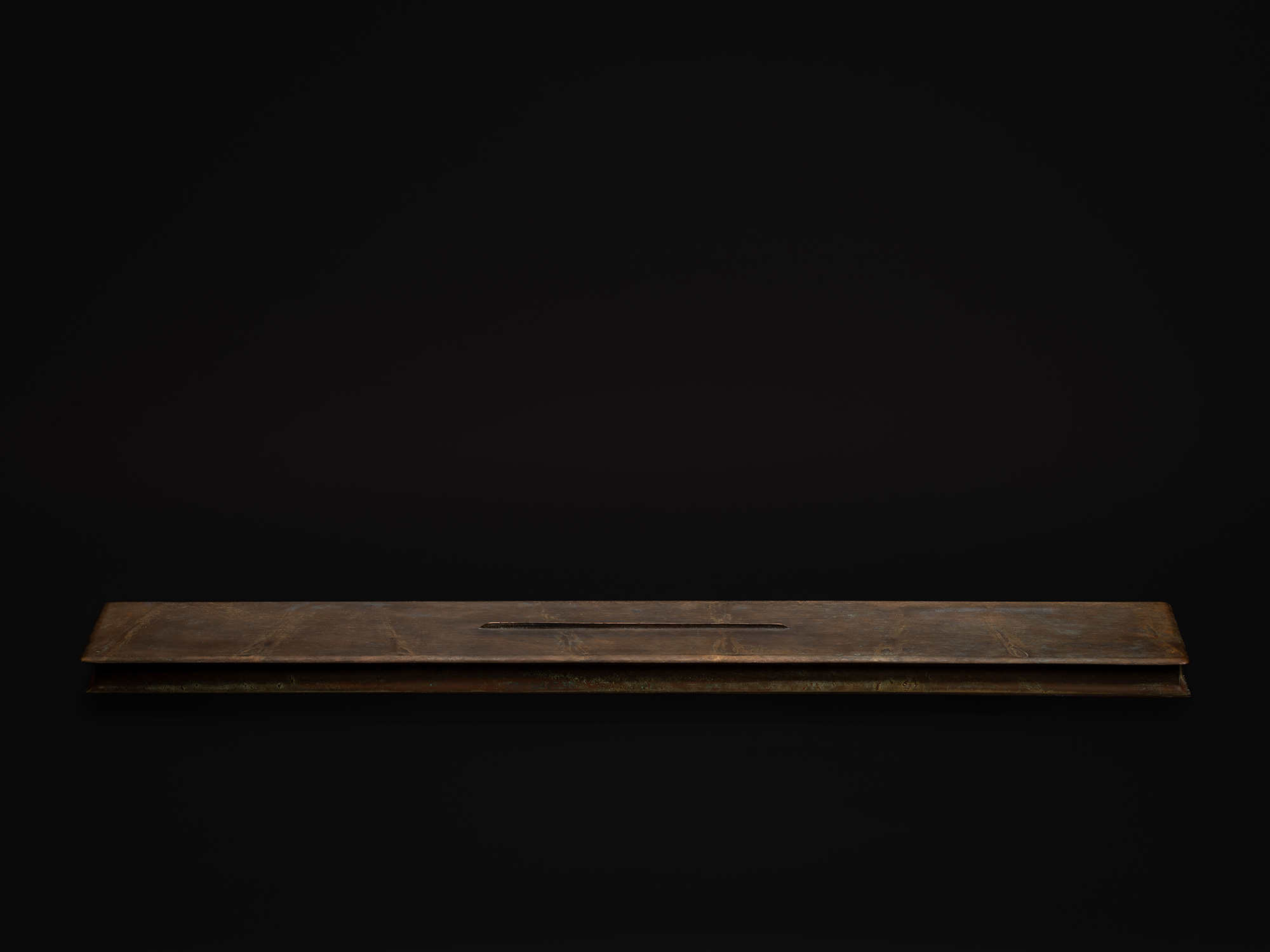 Rectangular bronze sculpture by Koji Hatakeyama, featuring a long, low horizontal form with a subtle...