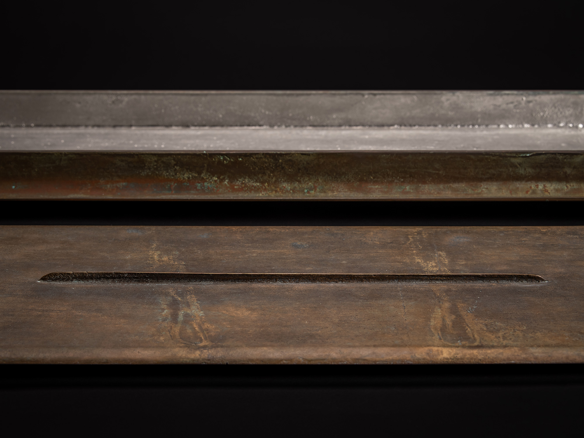 Close up of Rectangular bronze sculpture by Koji Hatakeyama, featuring a long, low horizontal form...