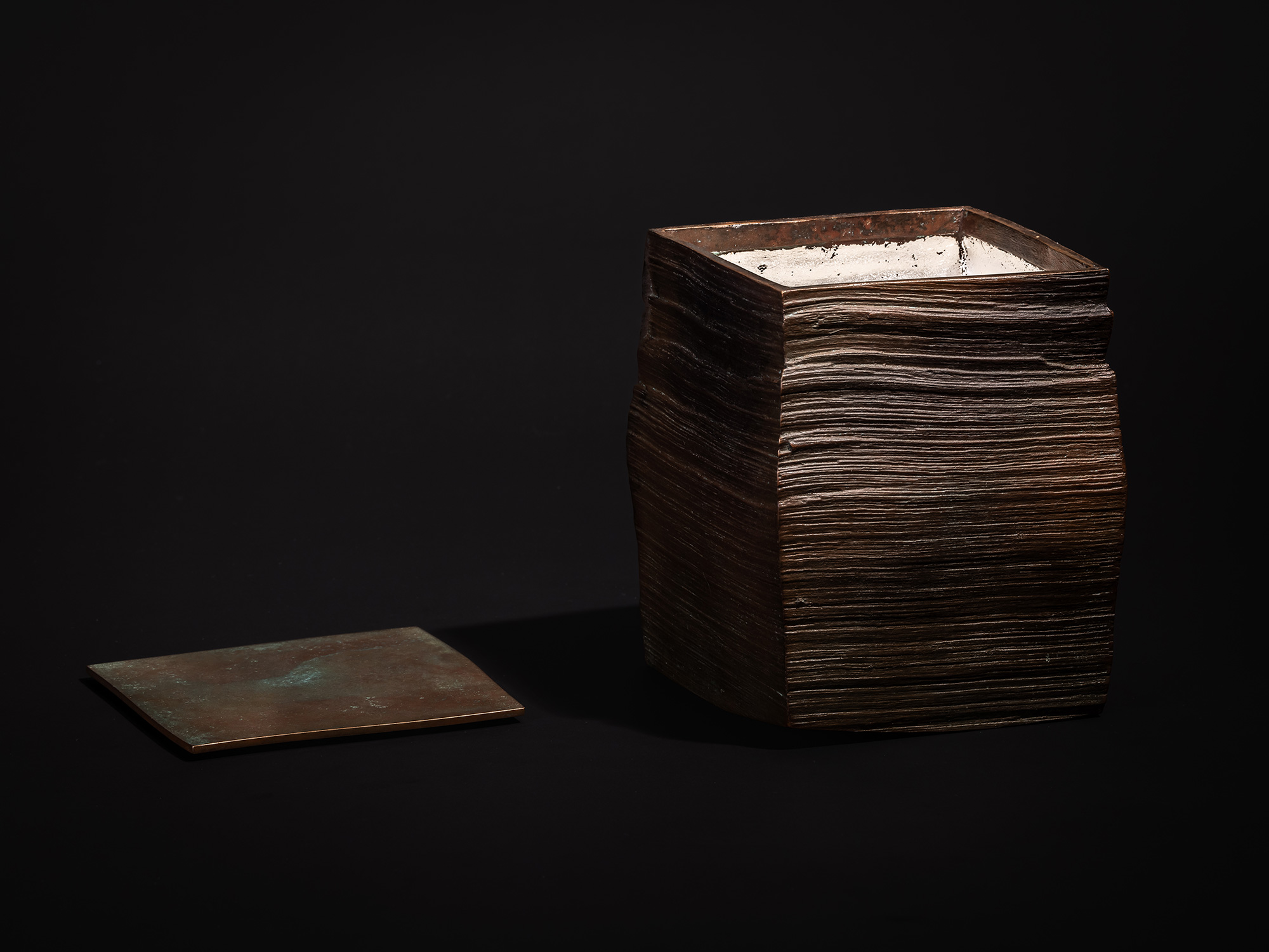 Square Strips by Koji Hatakeyama, shown with the lid set aside, revealing a glimpse of the softly...