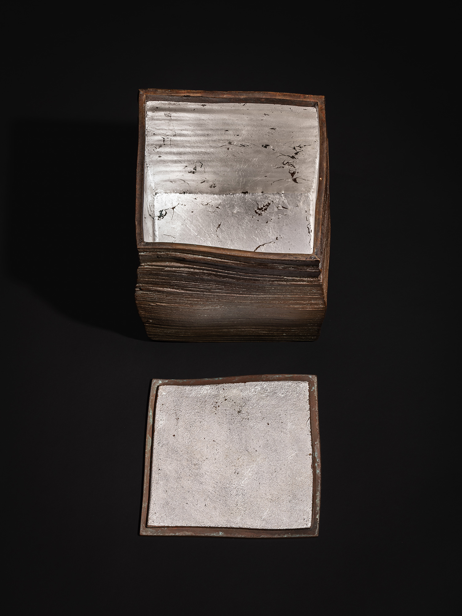 Aerial view of Square Strips by Koji Hatakeyama, showing the bronze box with the lid removed, revealing...