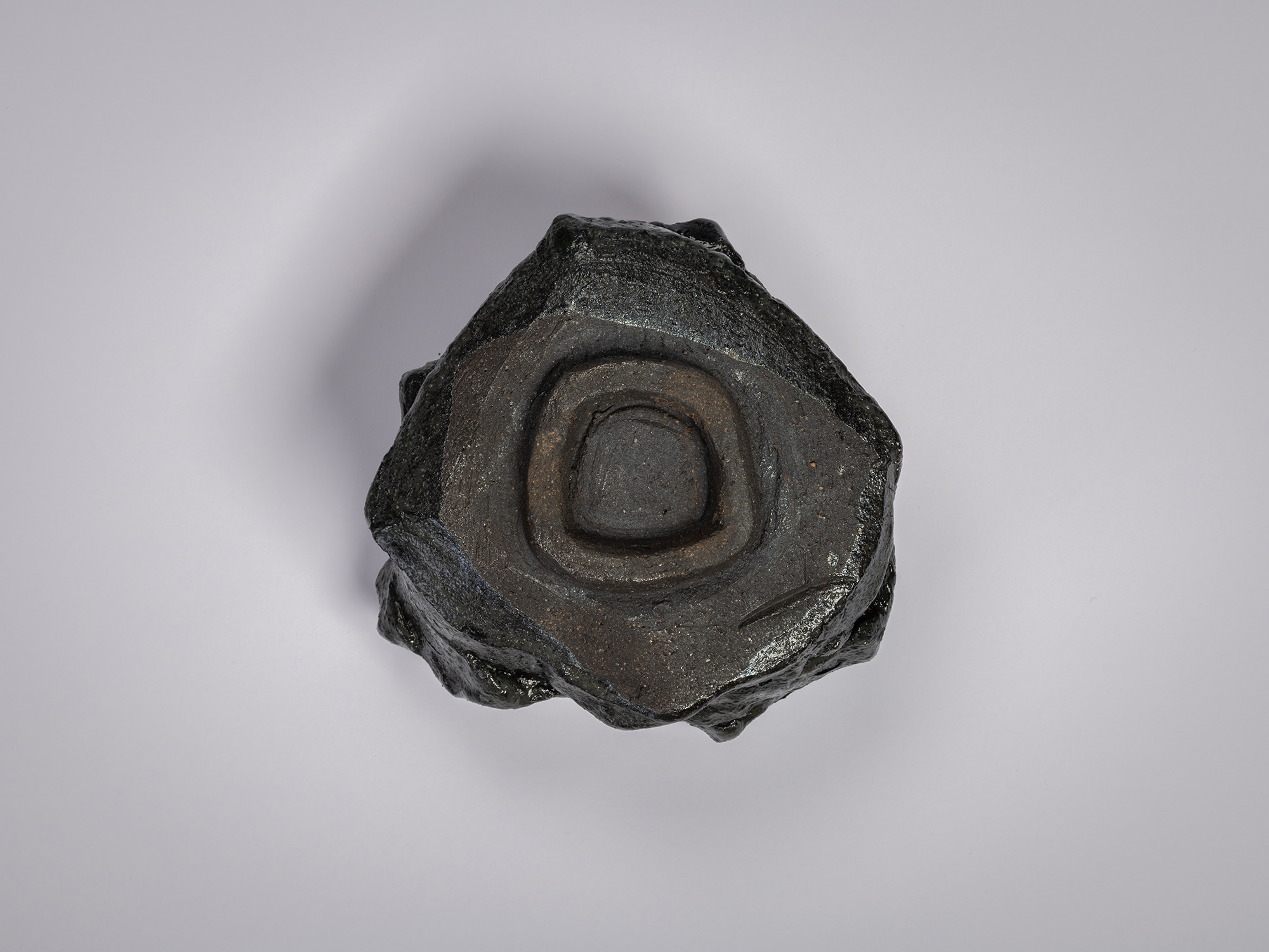 Shōzō Michikawa, Tea Bowl Black. Underside view of a sculptural ceramic tea bowl showing a carved...