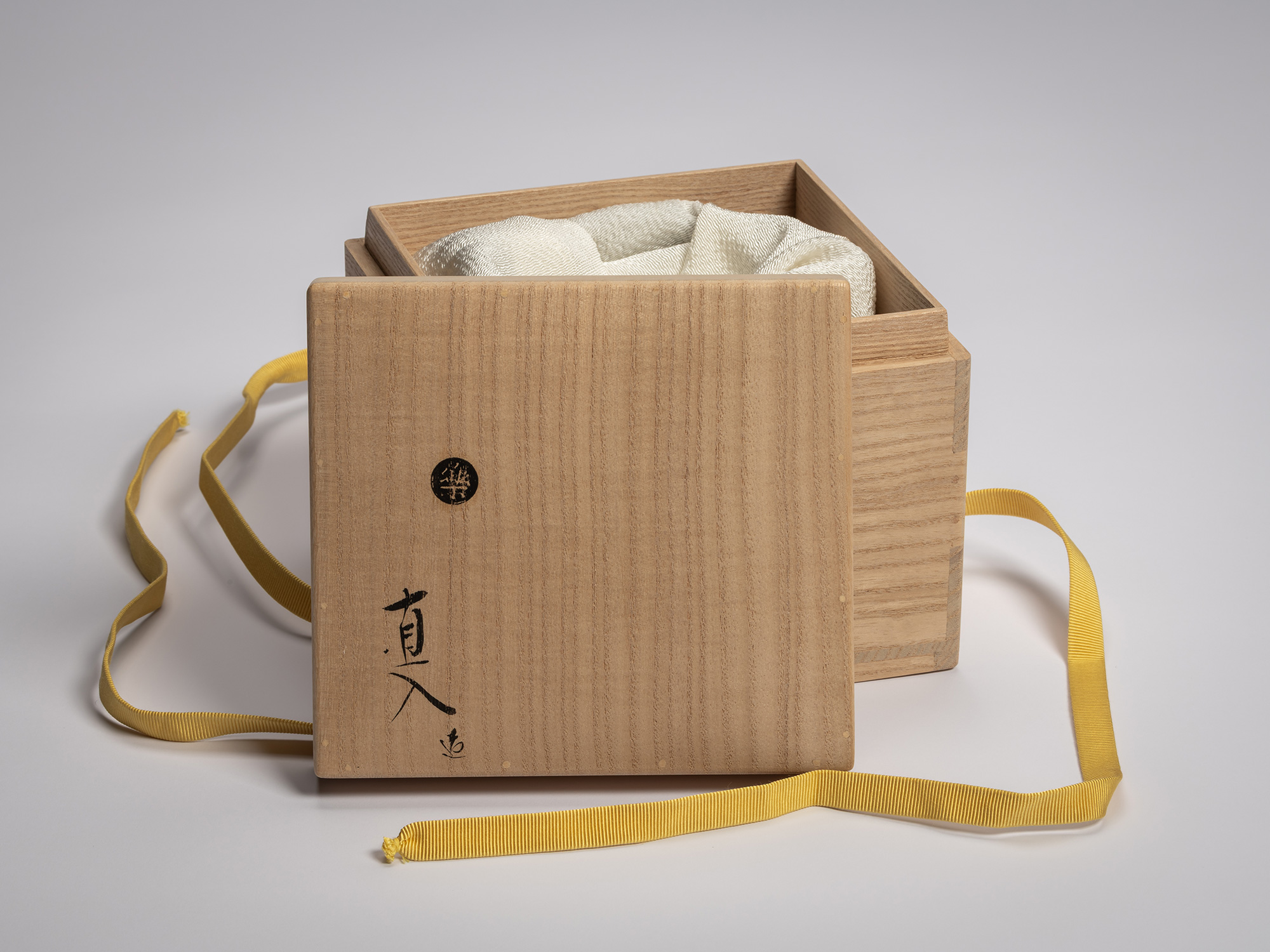 Paulownia wood tomobako lid for Raku XV tea bowl titled Usokuseki, featuring brushed Japanese calligraphy...