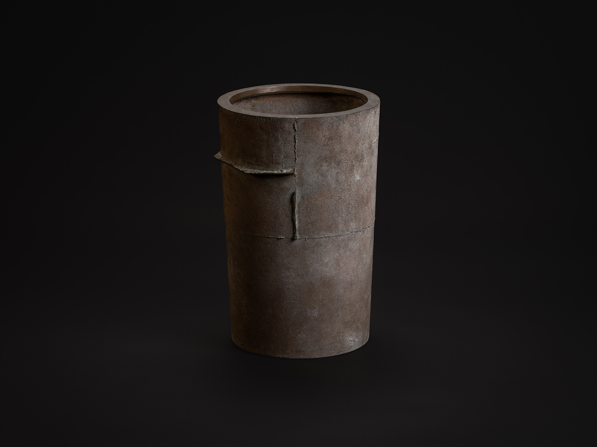Vessel with an Axis by Koji Hatakeyama, a tall cylindrical bronze vessel with a muted brown patina...