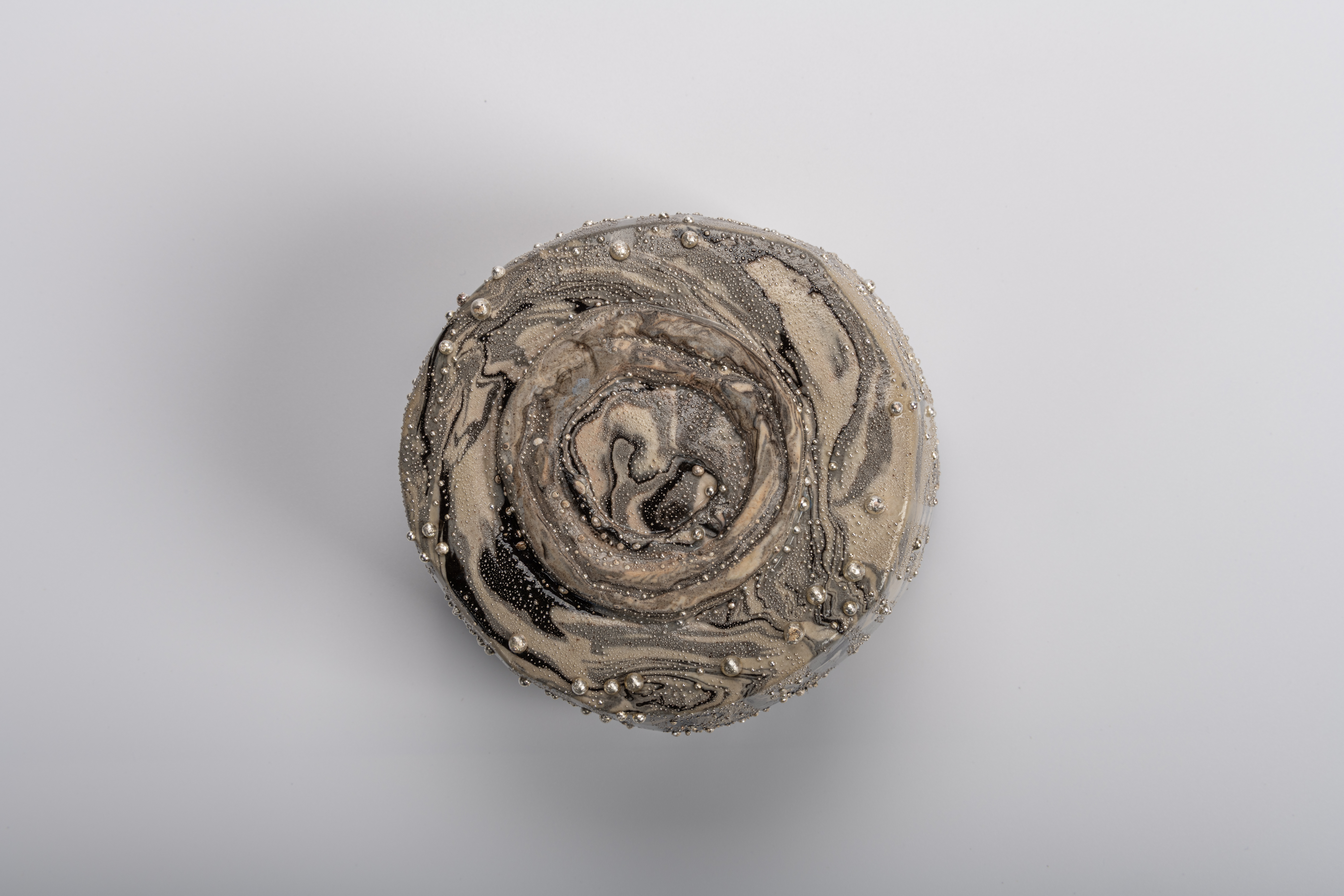 Foot (kōdai) of Takahiro Kondo’s “Wave Bowl: Tsunami” tea bowl, showing concentric carved ring...