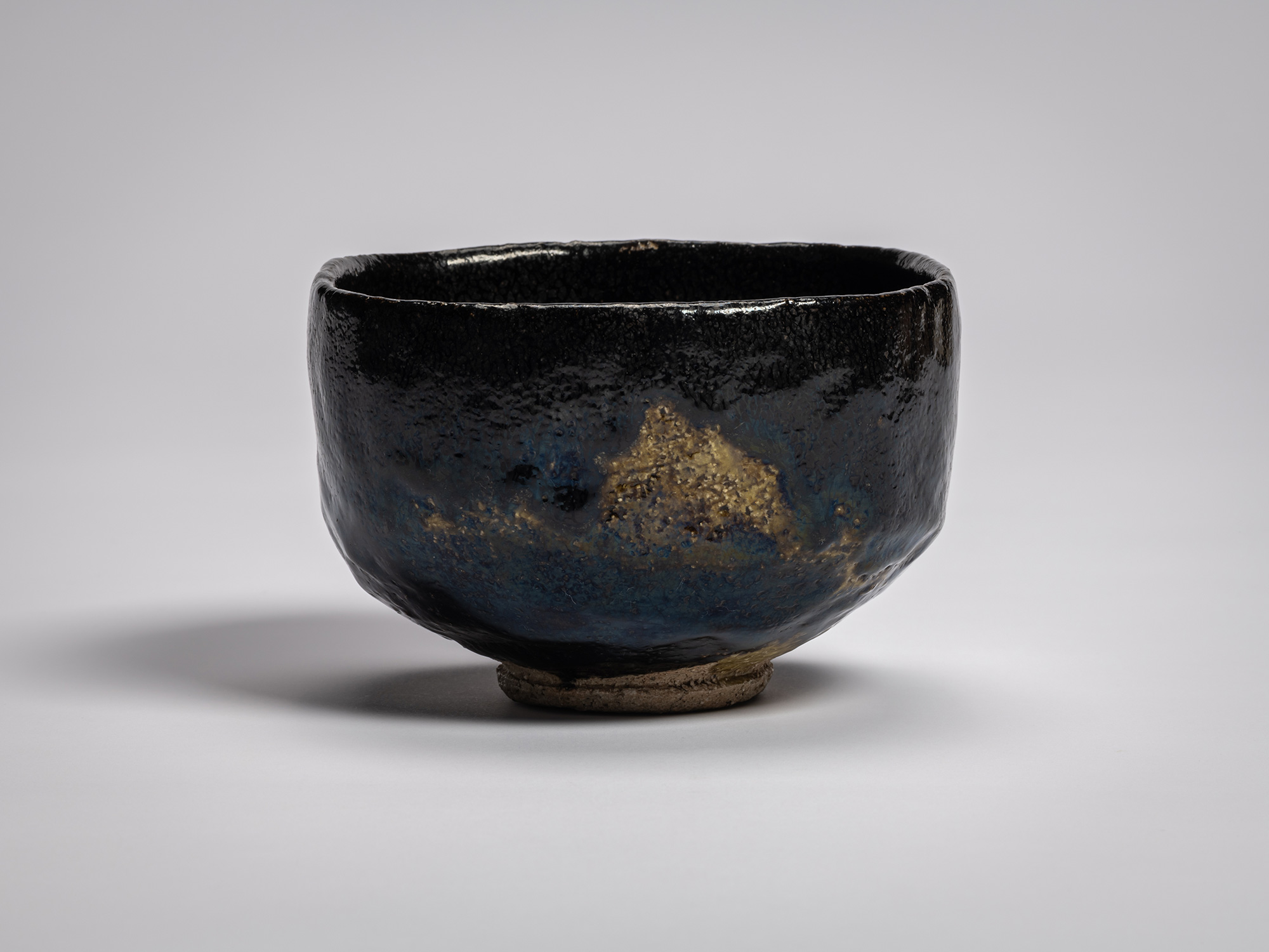 Black Raku tea bowl Yōbō Shungen by Raku IX, with a deep, softly rounded form and subtly irregular...