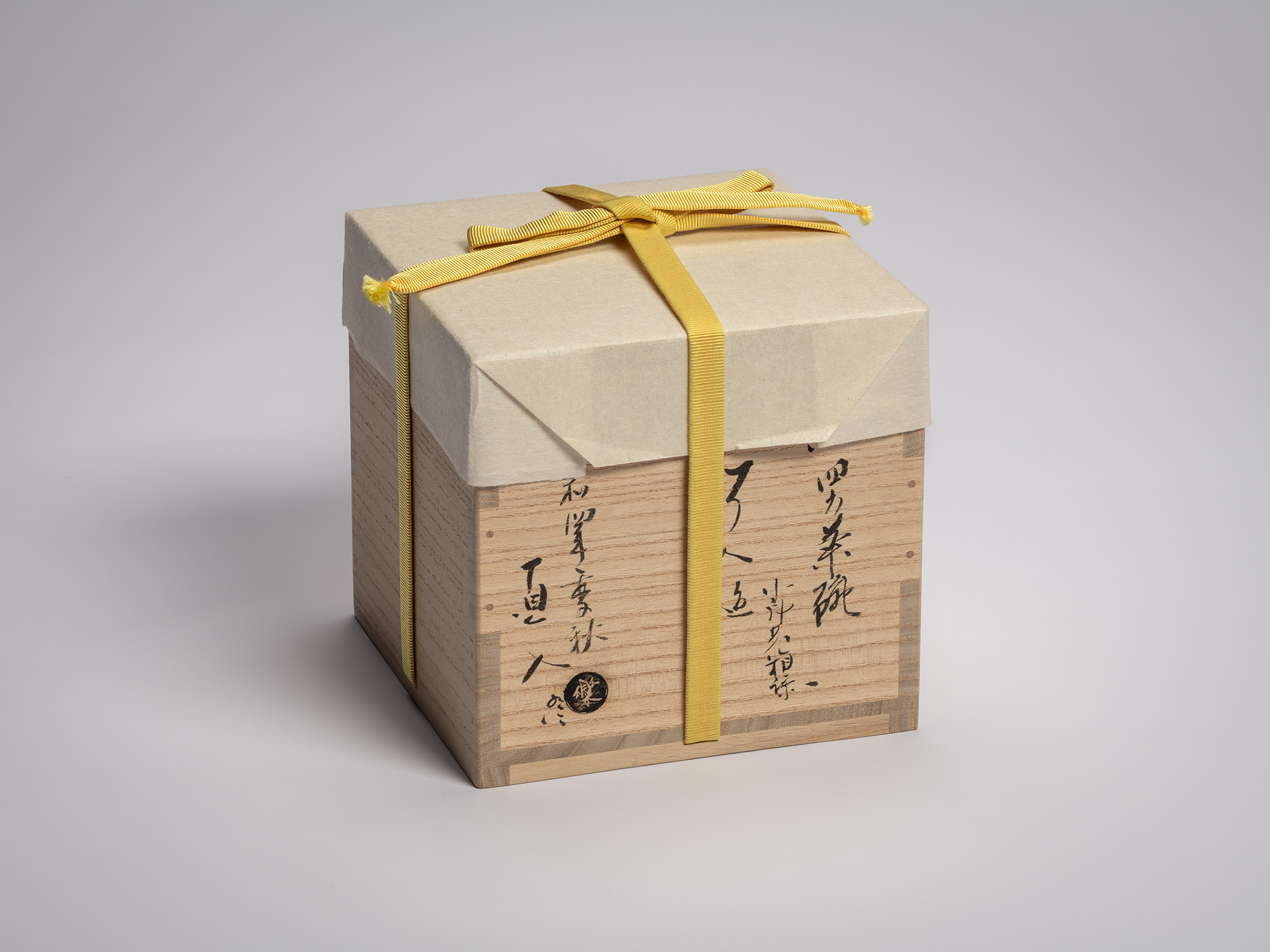 Wooden storage box for the tea bowl Yōbō Shungen by Raku IX, wrapped with pale washi paper and...