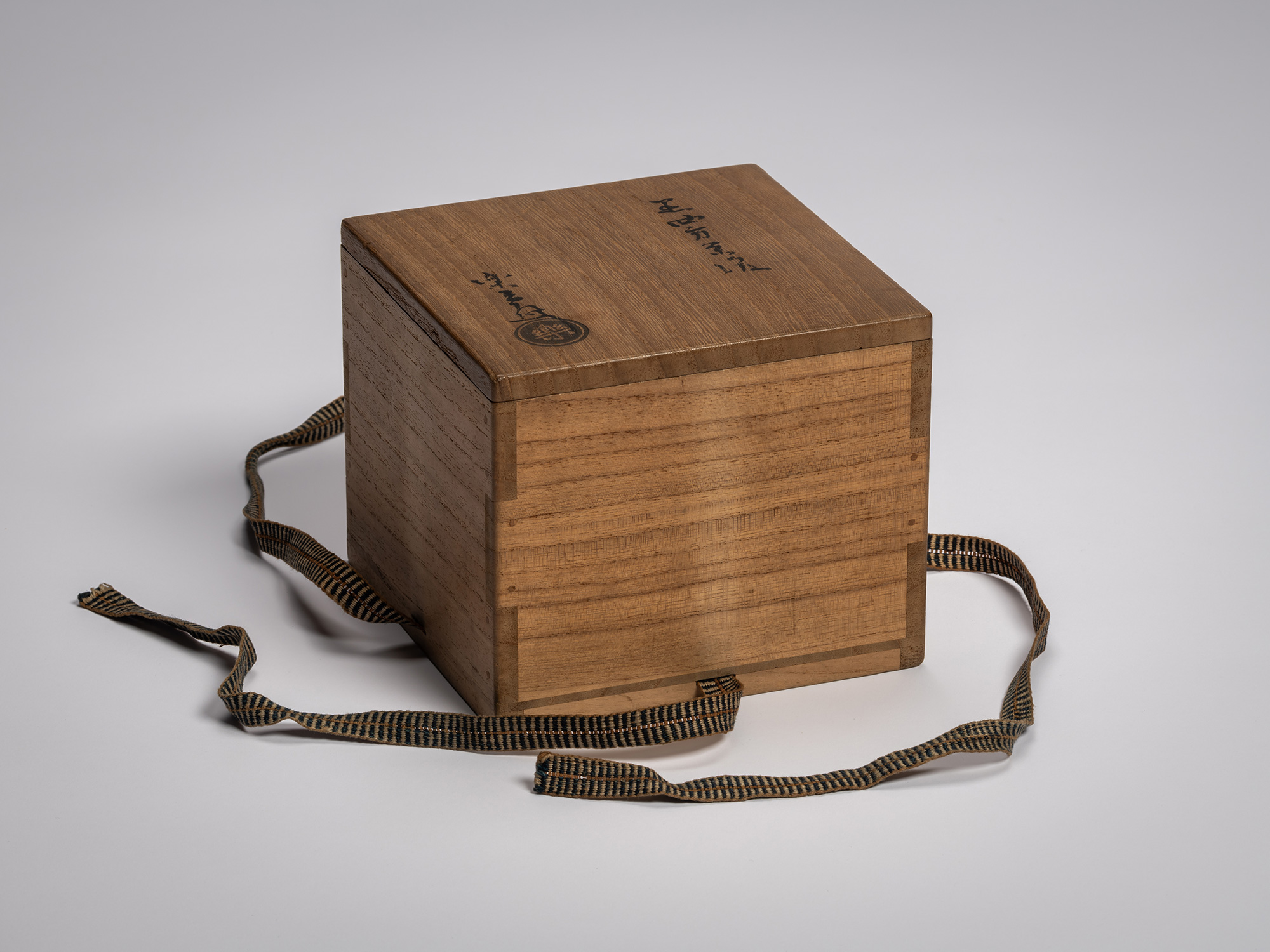 Interior wooden storage box for the tea bowl Yōbō Shungen by Raku IX, shown closed with its fitted...
