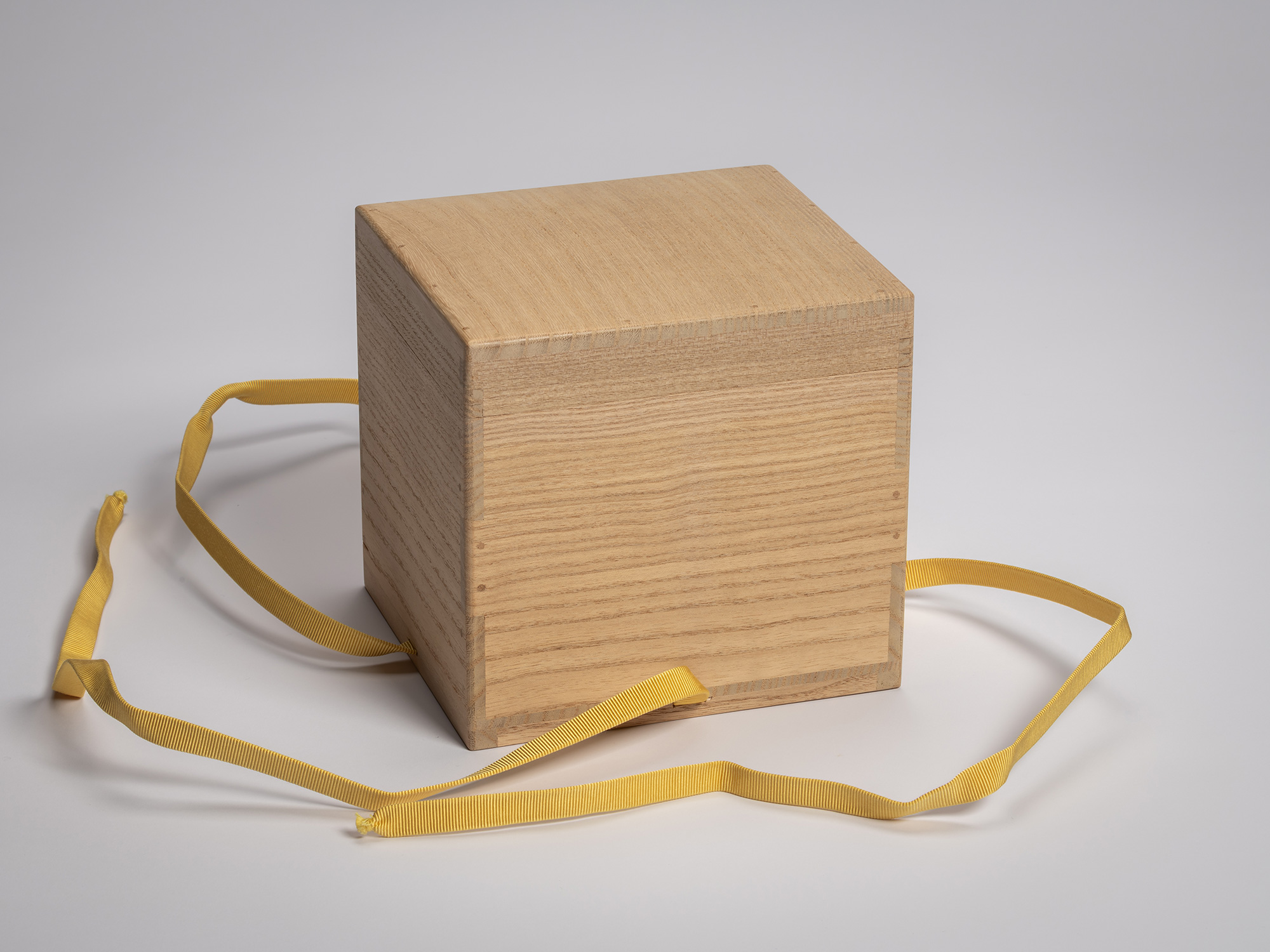 Wooden artist box containing the tea bowl Zan by Raku XV (Jikinyū), shown from the back with the...