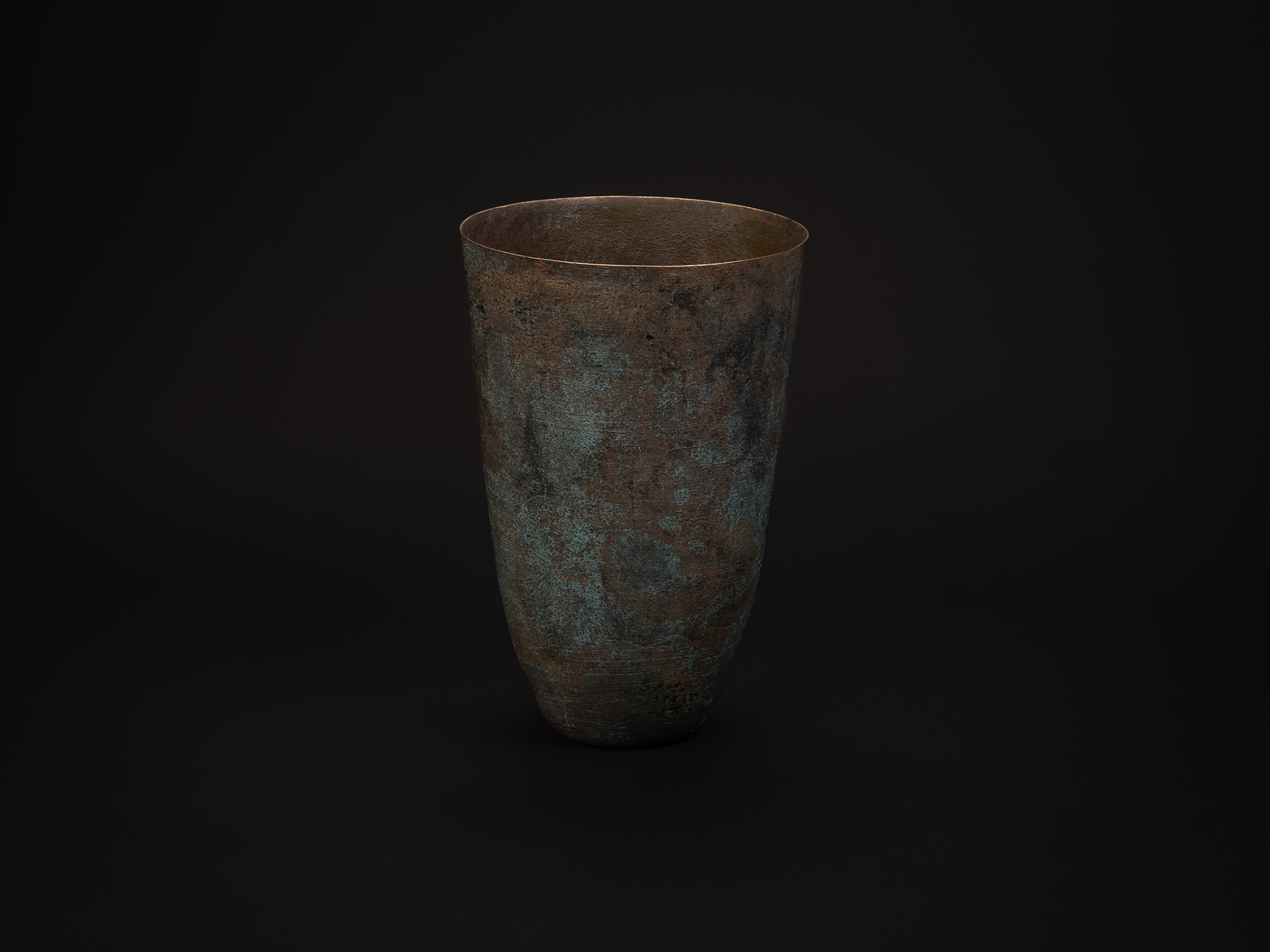 Tall cylindrical bronze vessel titled Bronze No. 1 by Hatakeyama, with a slightly flared rim and...