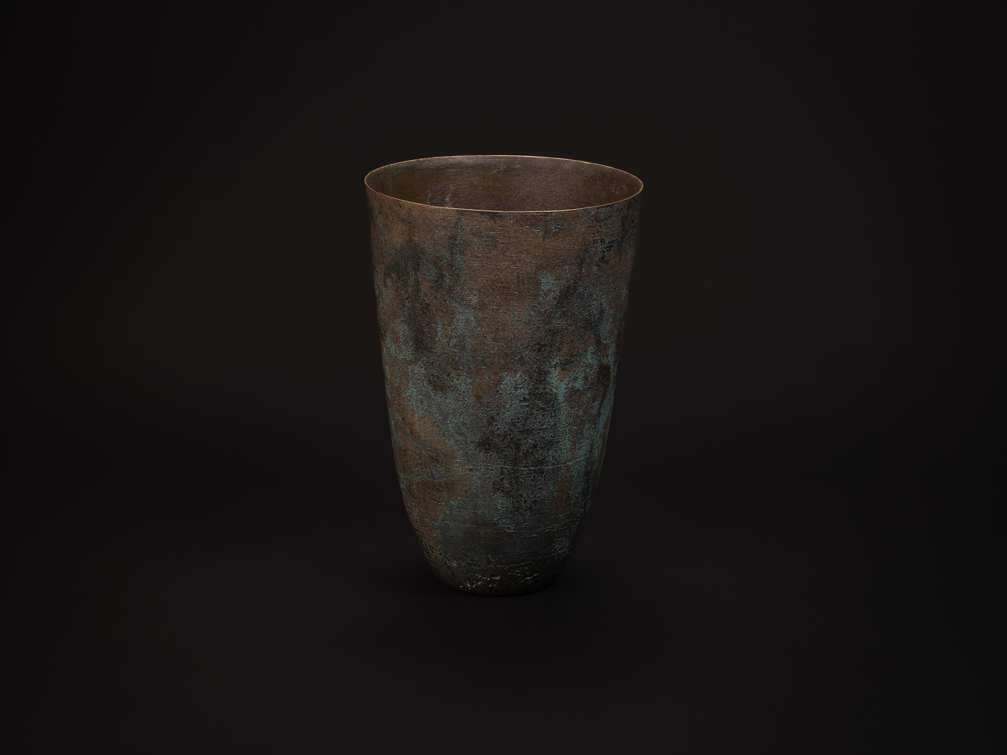 Tall cylindrical bronze vessel titled Bronze No. 1 by Hatakeyama, with a slightly flared rim and...