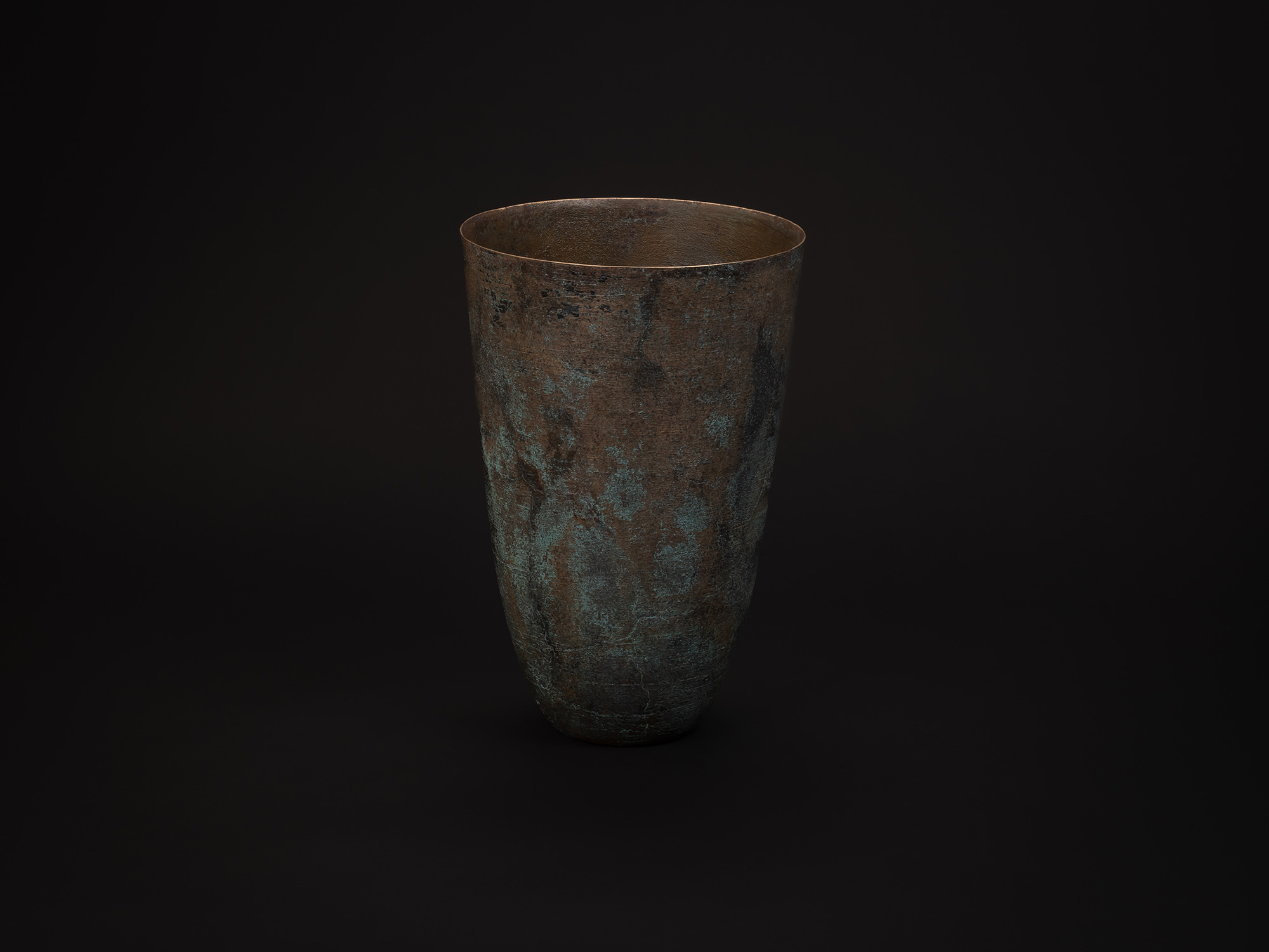 Tall cylindrical bronze vessel titled Bronze No. 1 by Hatakeyama, with a slightly flared rim and...